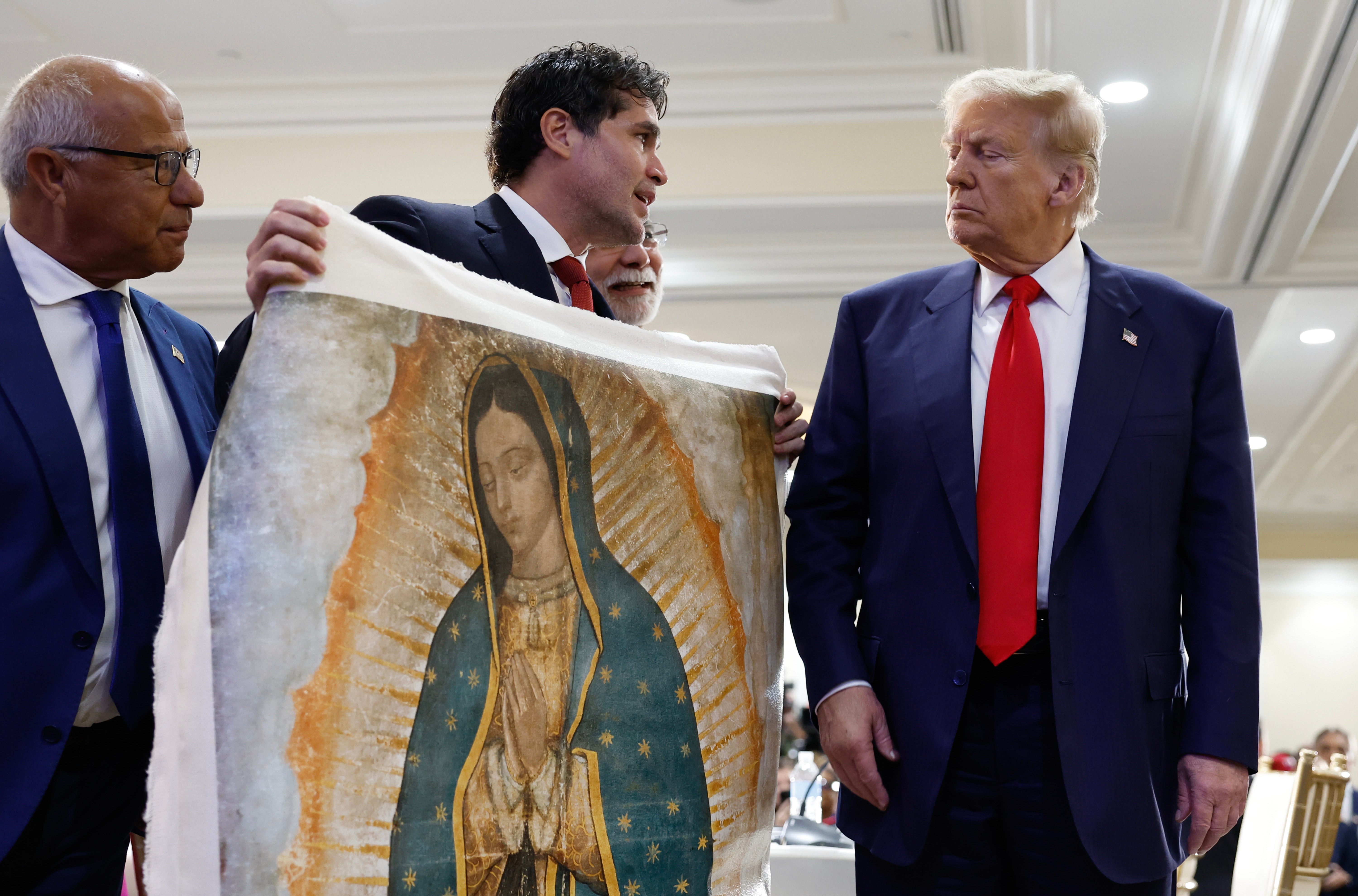 Trump is presented with a piece of art by Mexican actor Eduardo Verástegui that depicts the Virgin Mary