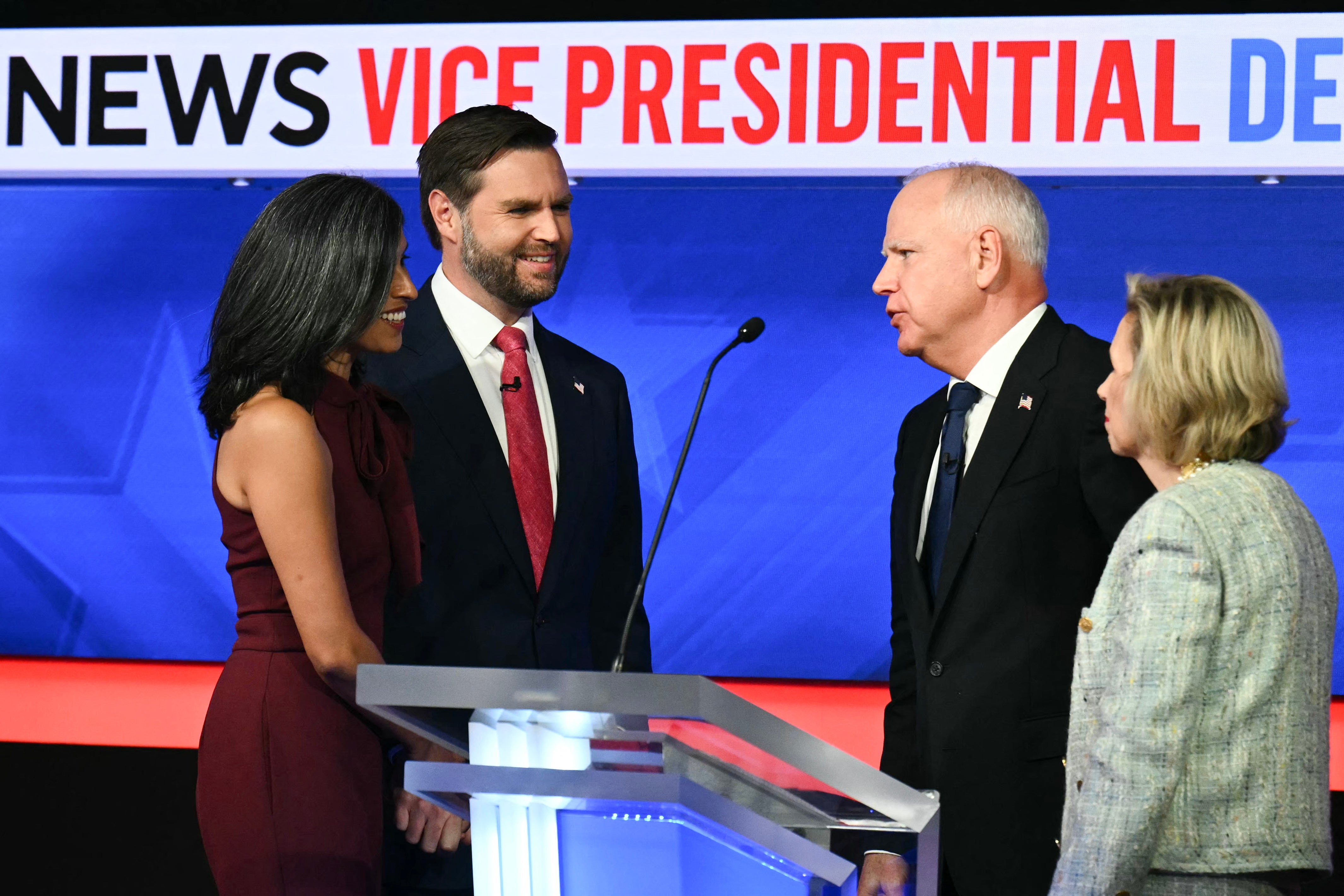 JD Vance, Usha Vance, Tim Walz and Gwen Walz gather on stage after the two vice presidential candidates debated.