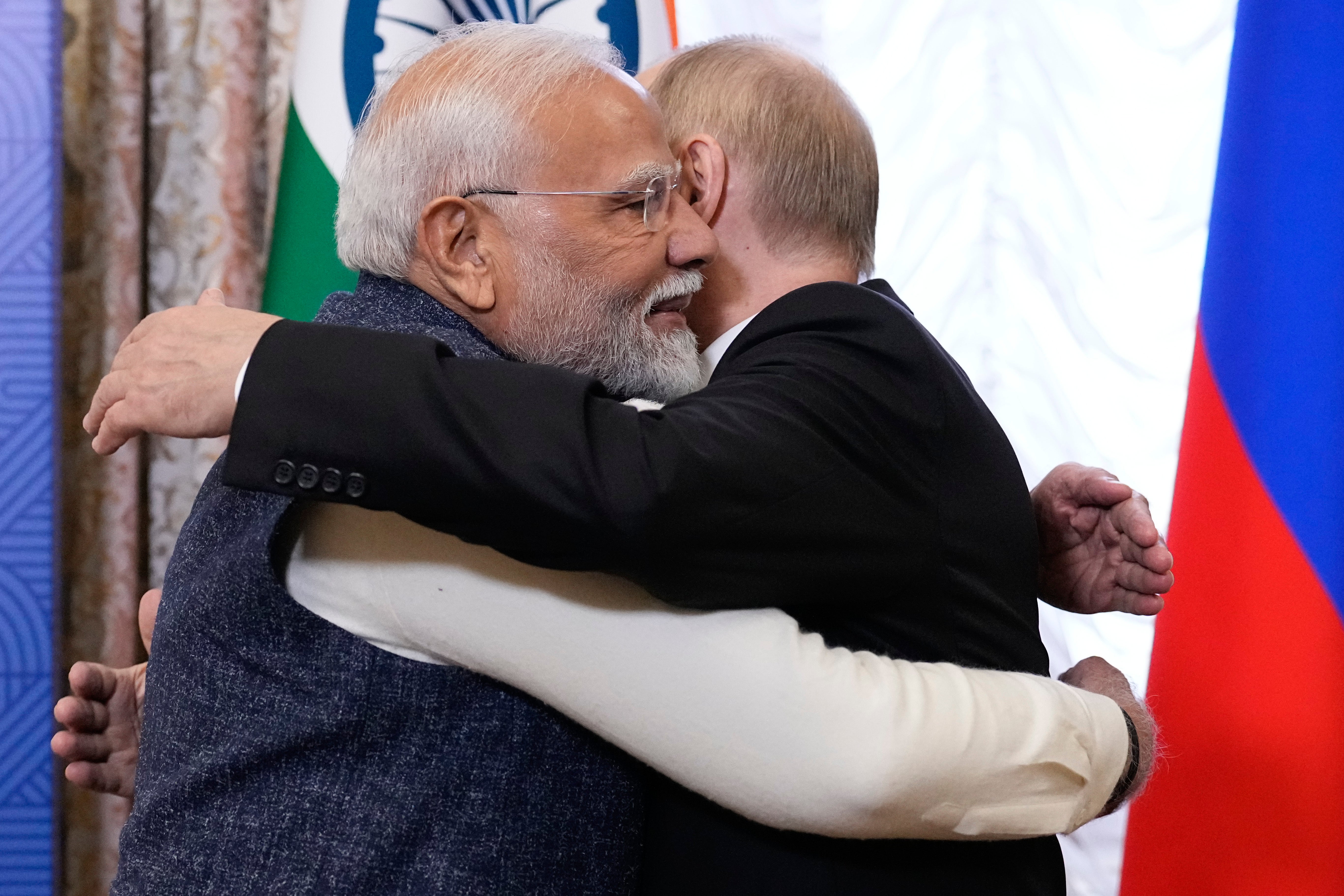 Russian president Vladimir Putin, right, embraces Indian prime minister Narendra Modi during their meeting on the sidelines of Brics summit