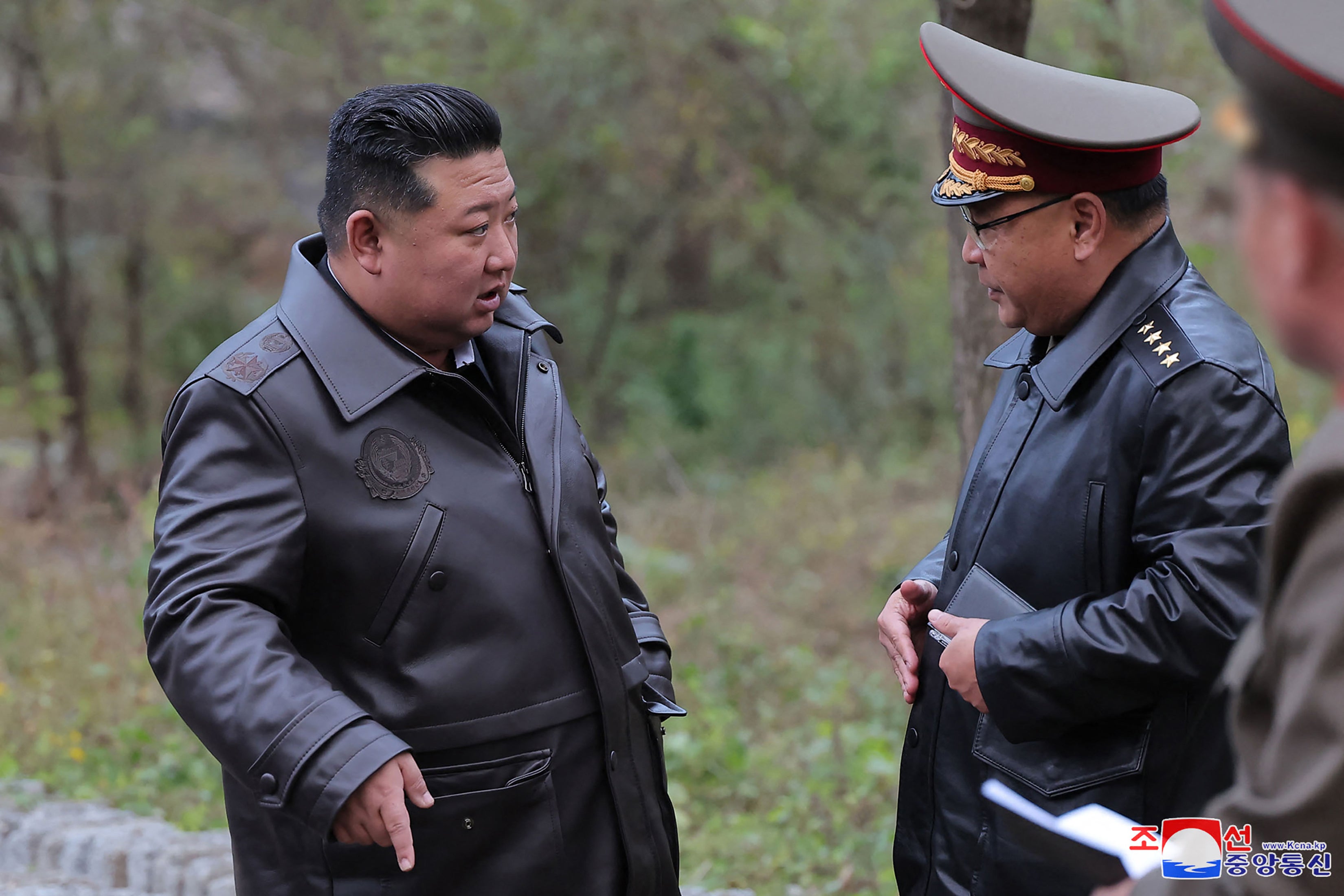 North Korea’s leader Kim Jong Un (L) visiting a strategic missile base at an undisclosed location in North Korea