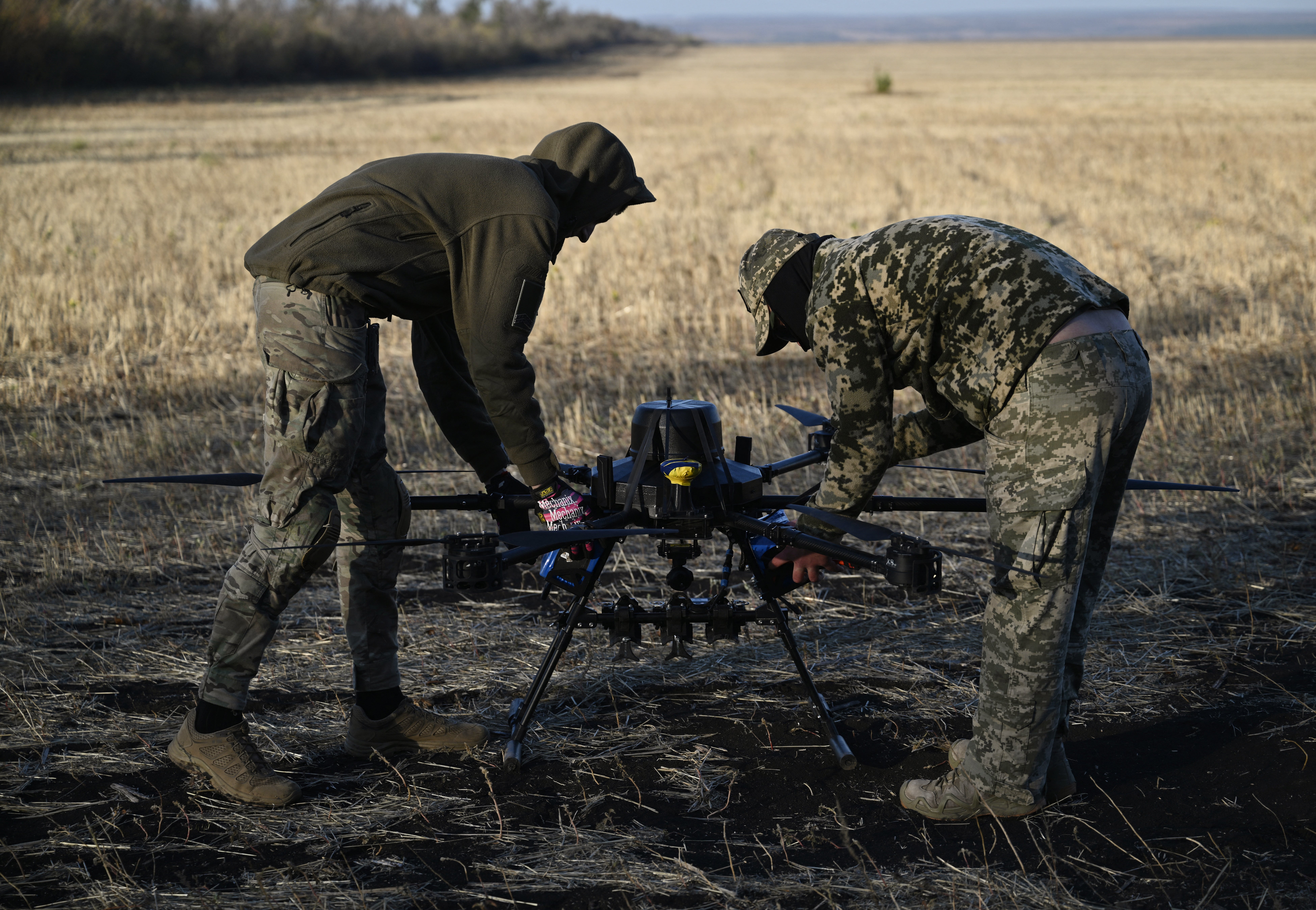 Ukrainian servicemen of the 30th separate mechanized brigade prepare to run tests flights of a hexacopter drone ahead of battle mission in the eastern Donetsk region