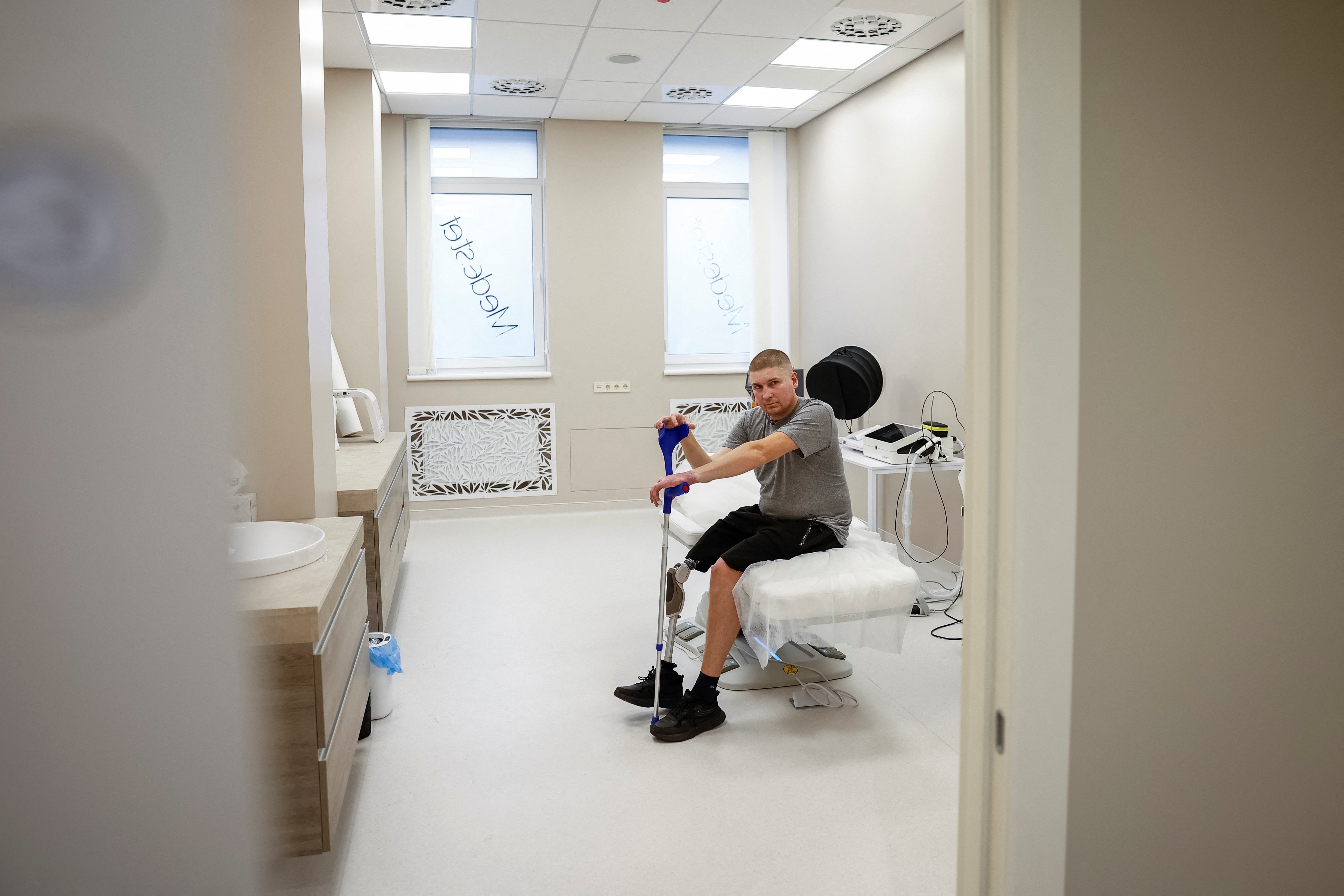 Ihor Khomets, a former Ukrainian serviceman, who was wounded at a front line, is seen in a clinic, which treats scars, before a medical procedure, in Lviv