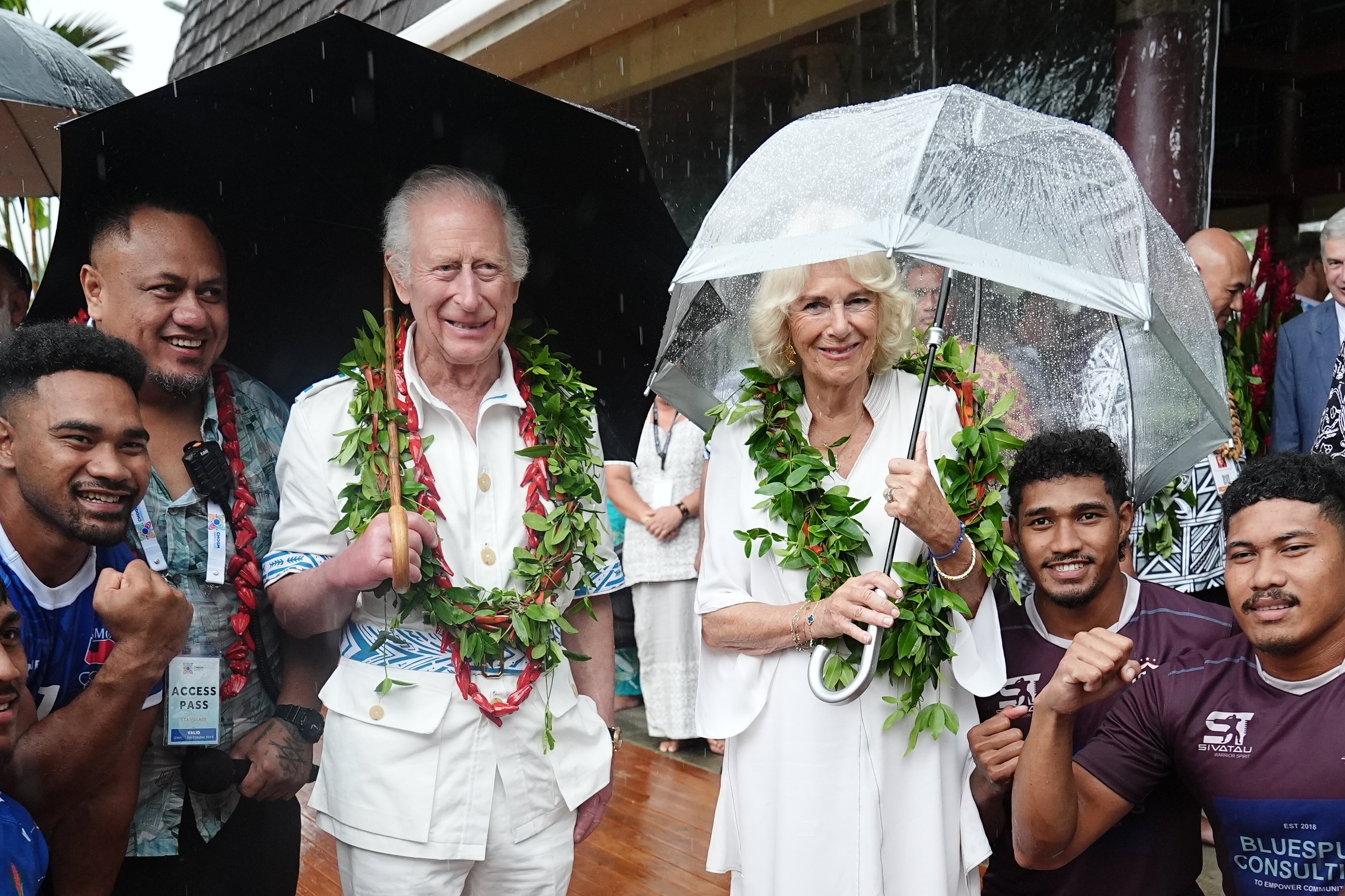 King Charles and Queen Camilla with members of a rugby team during a visit to the Samoan Cultural Village in Apia, which celebrates the importance of traditional arts, crafts, culture, enterprise and sport in Samoa, on day five of the royal visit to Samoa