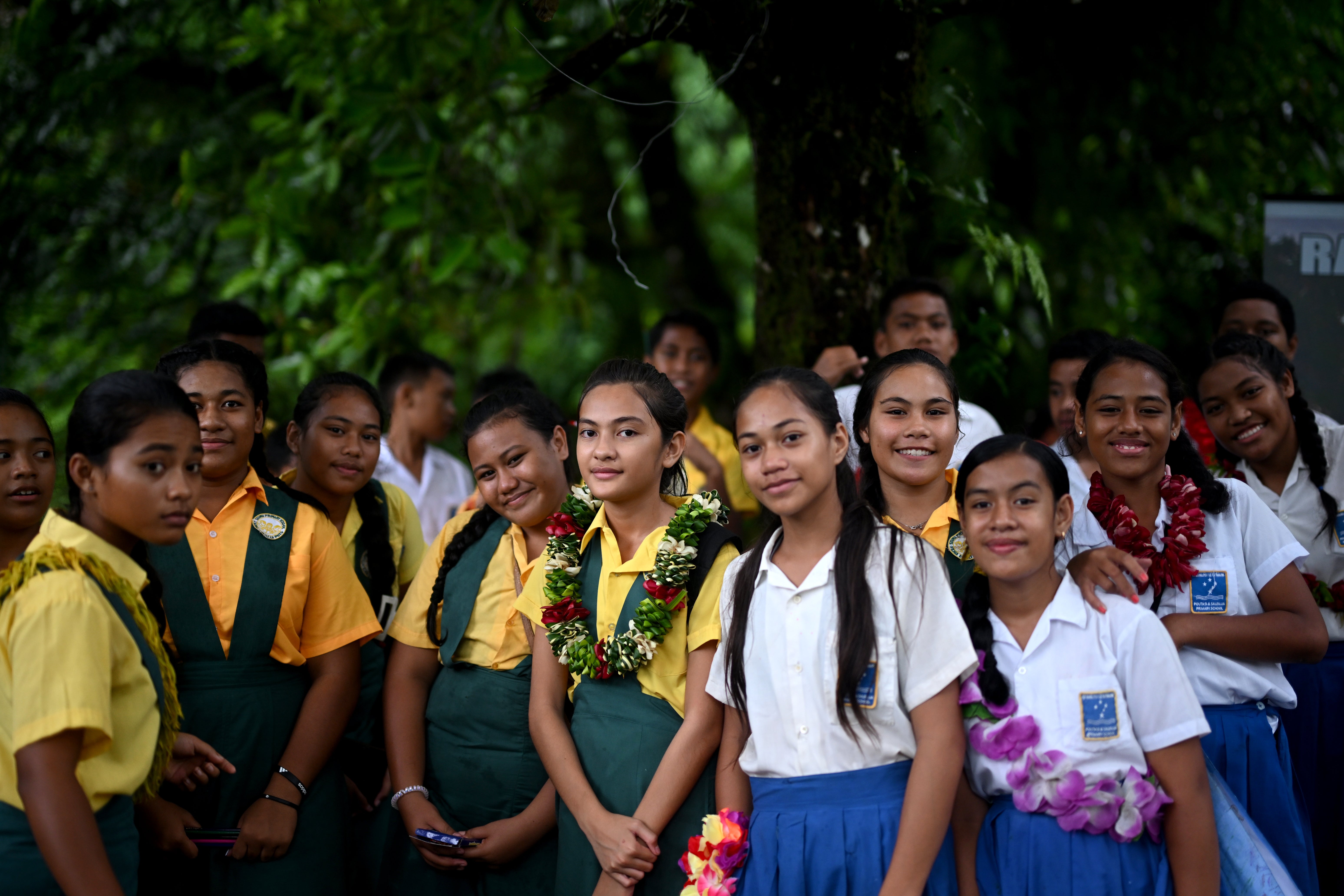 Children wait for King Charles to arrive at the national park