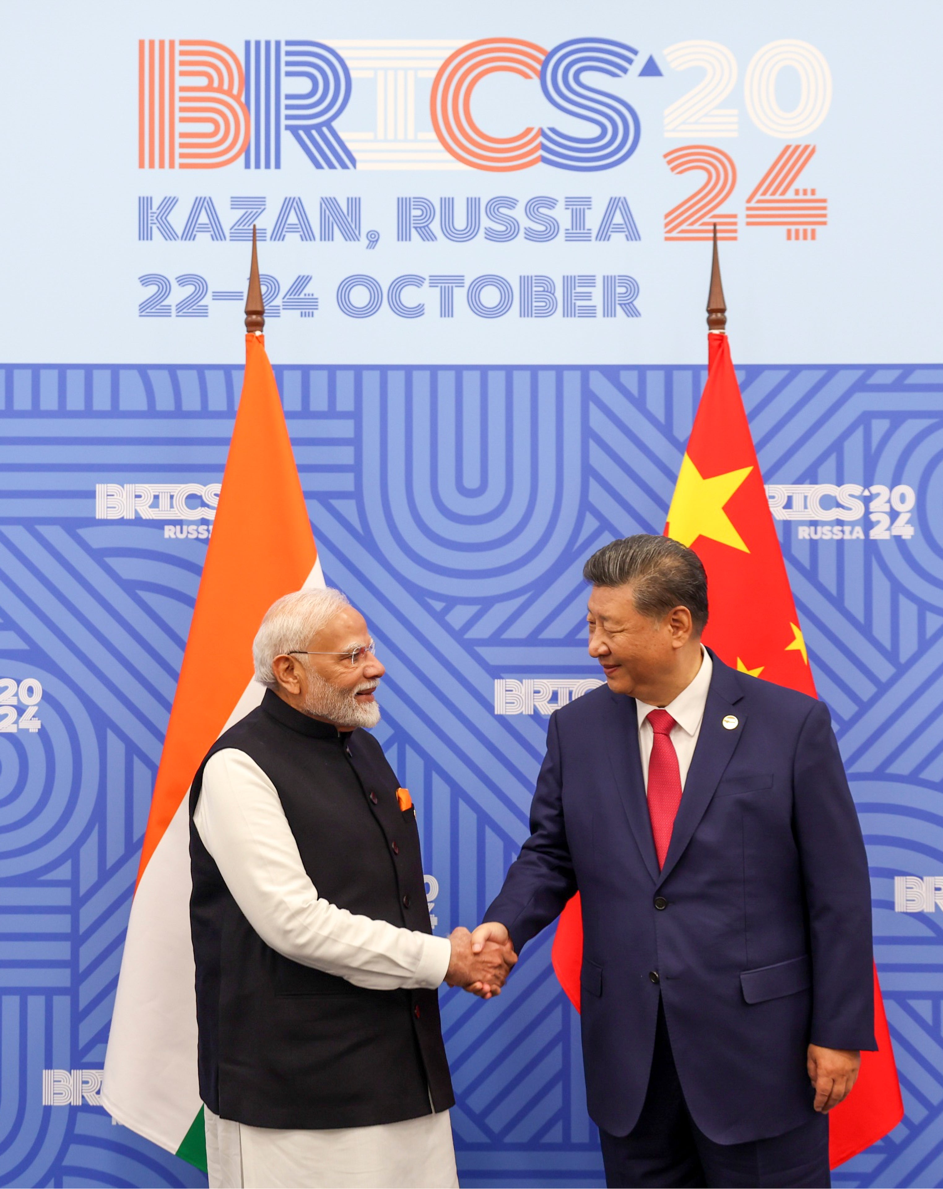 Chinese and Indian leader shake hands after concluding bilateral meeting