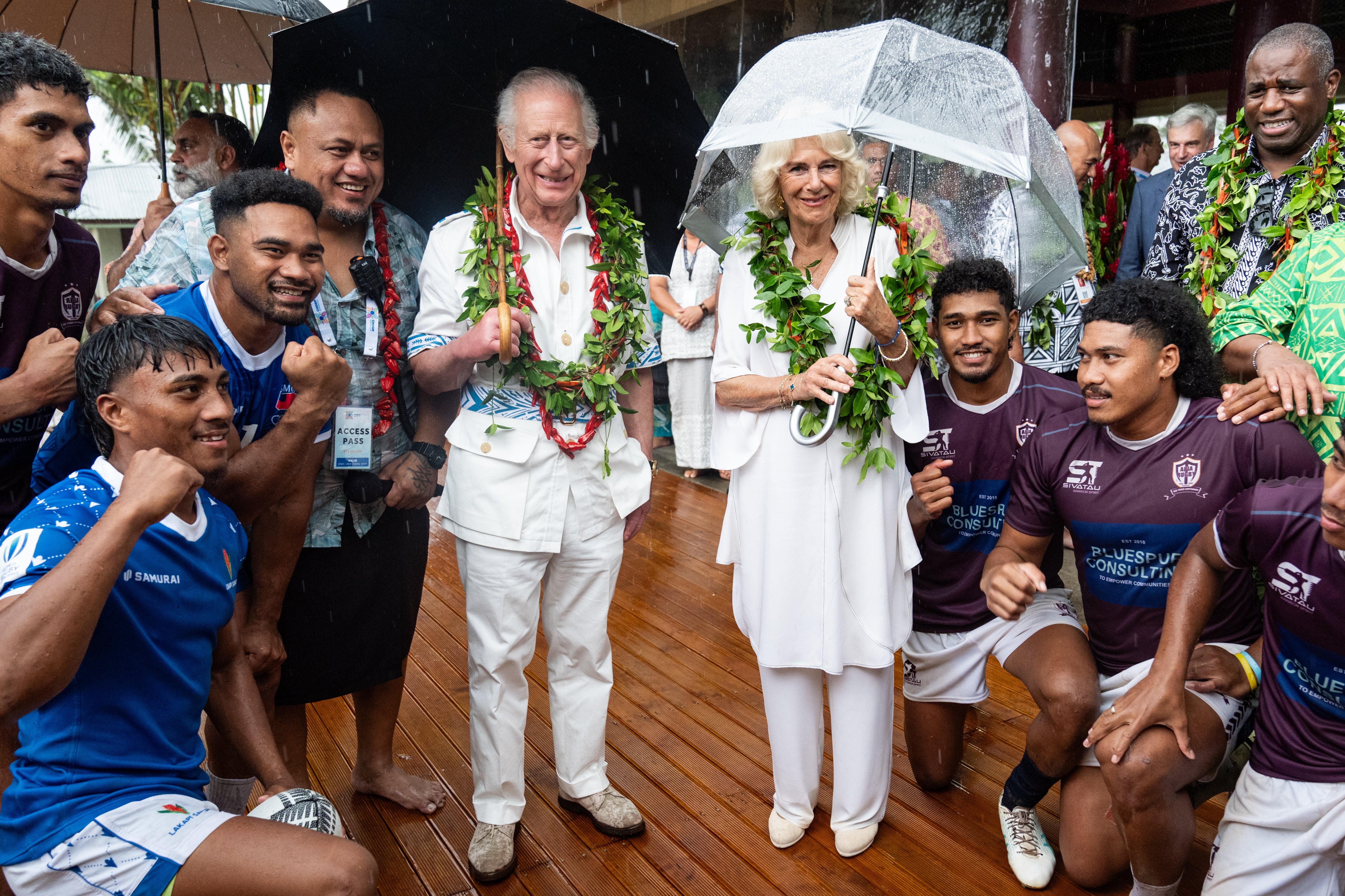 King Charles and Queen Camilla with members of the Apia rugby team rugby team during a visit to the Samoan Cultural Village in Apia