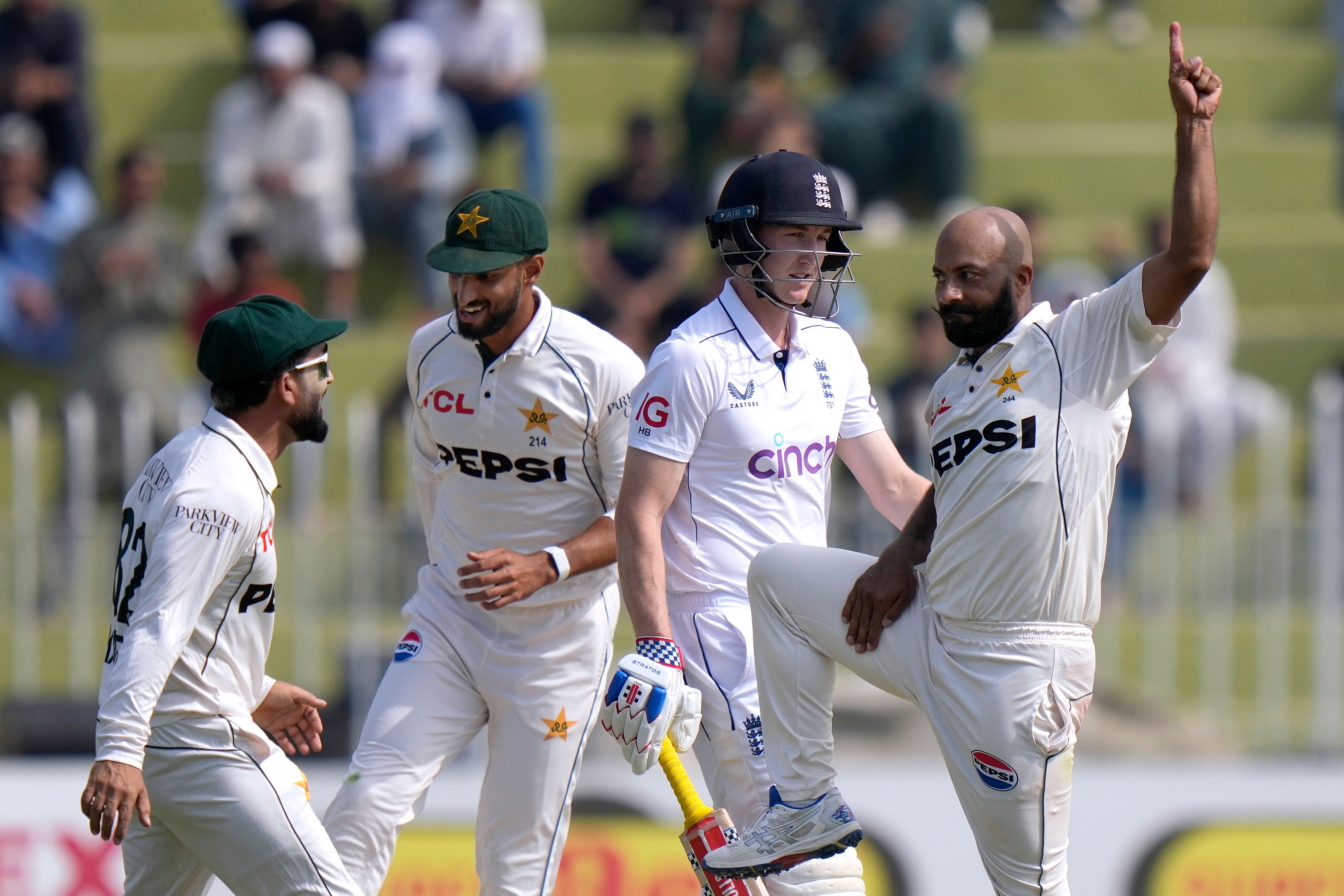 Pakistan’s Sajid Khan, right, celebrates after taking the wicket of England’s Harry Brook, center, during the day one of third test cricket match between Pakistan and England, in Rawalpindi, Pakistan, Thursday, Oct. 24, 2024. (AP Photo/Anjum Naveed)