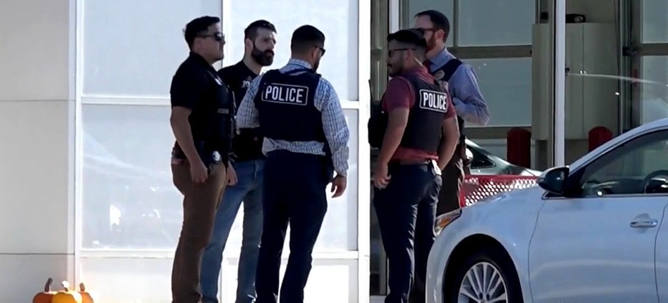 Police on the scene at the car dealership in DeKalb, Illinois