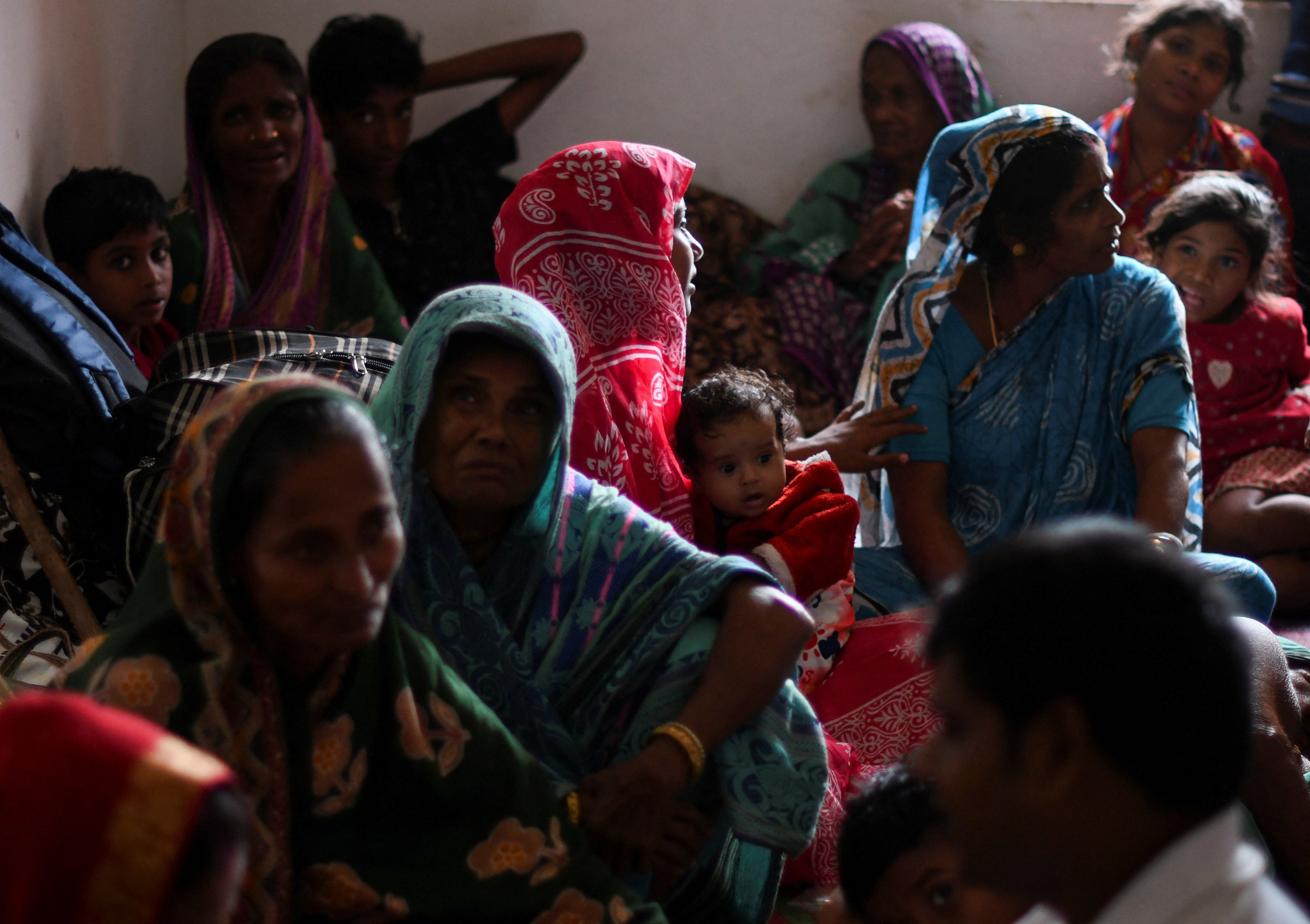 Evacuees from a village in Odisha sit inside a cyclone shelter near Dhamara