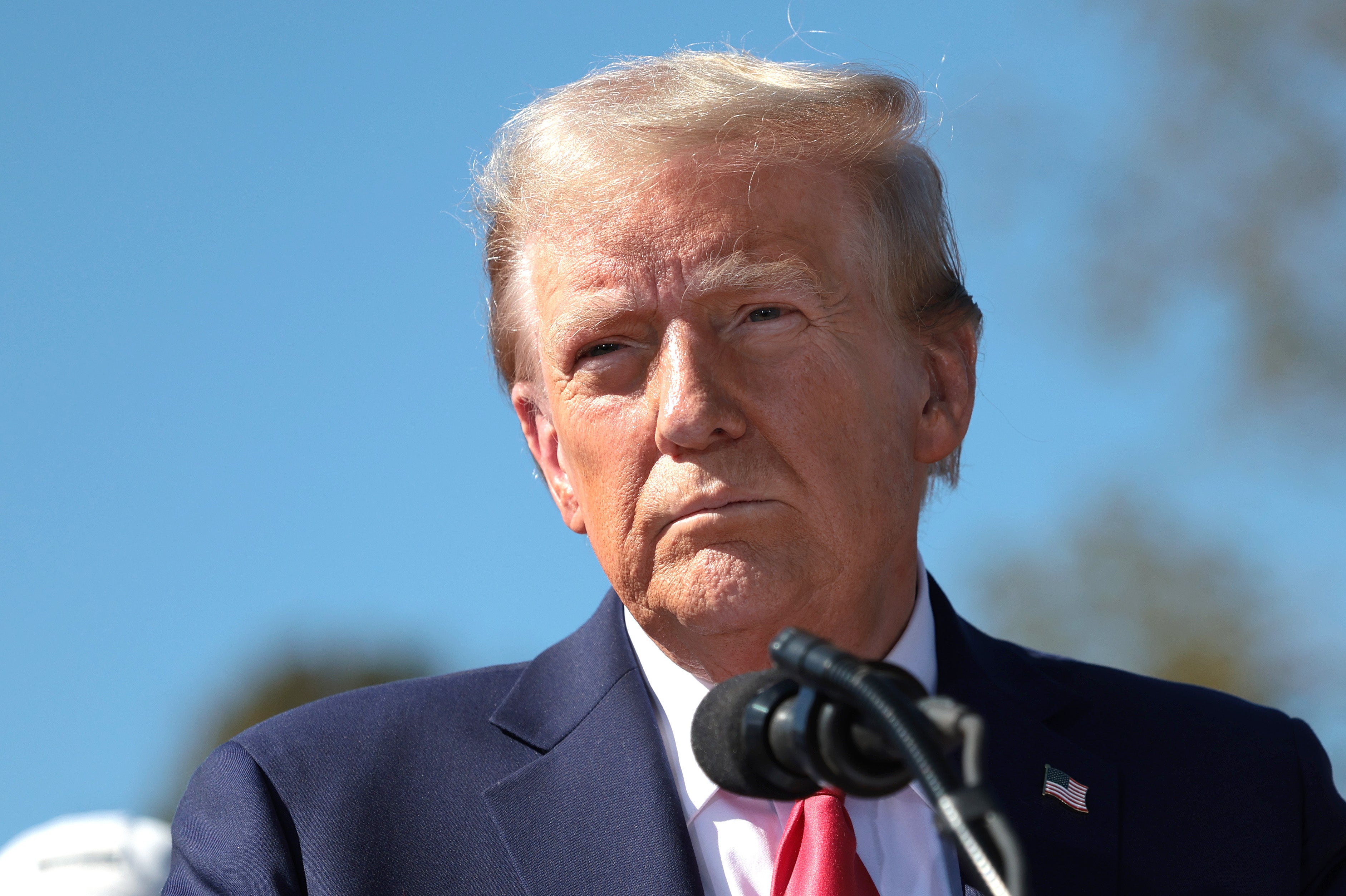 Donald Trump delivers remarks as he visits a neighborhood affected by Hurricane Helene on October 21 in Swannanoa, North Carolina. A new national poll shows him ahead of Harris less than two weeks before the election