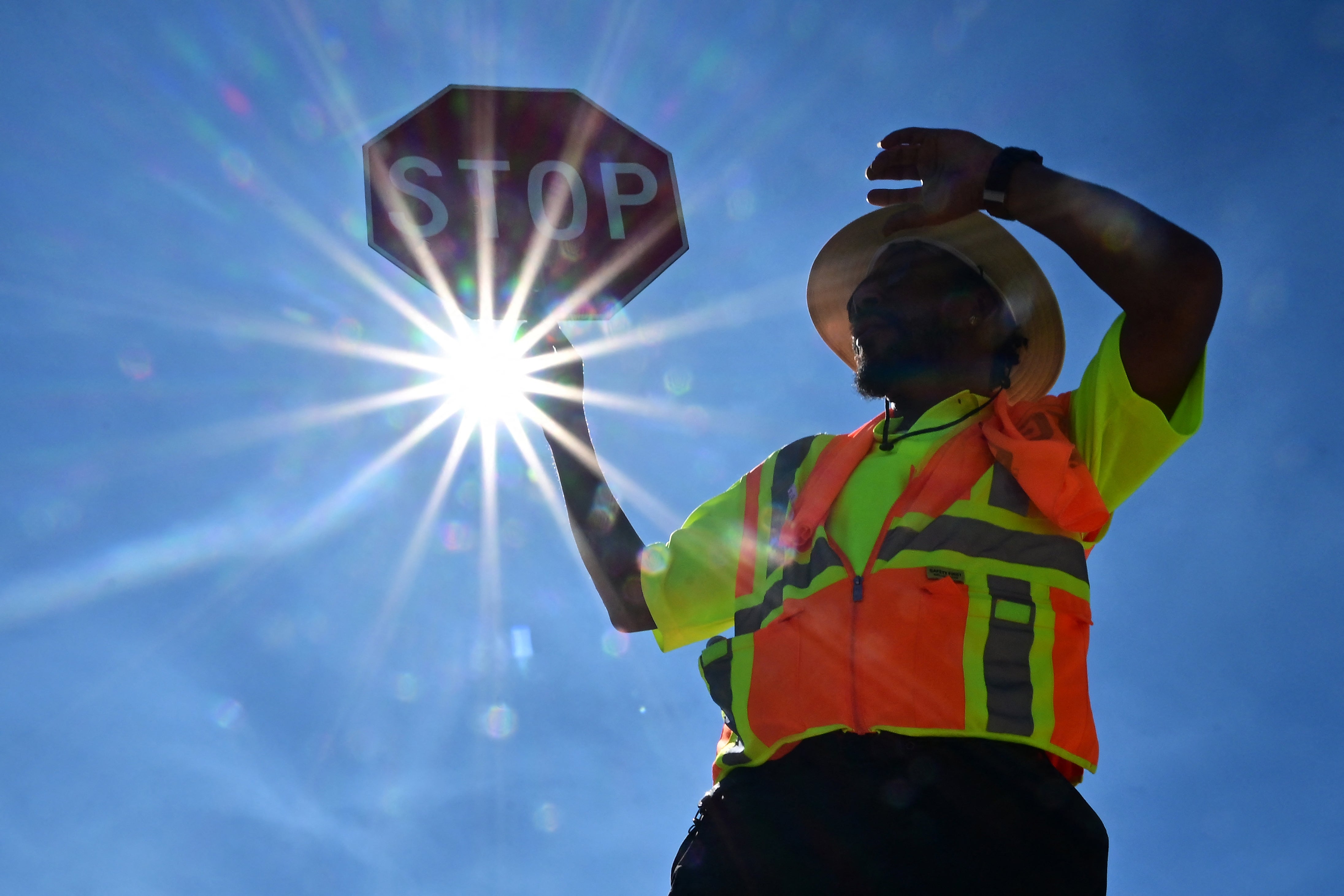 Traffic warden Rai Rogers mans his street corner under the hot sun in Las Vegas, Nevada, in July 2023. Temperatures there reached 106 degrees Fahrenheit. A UN study found the world is on track for a 3.1 degrees Celsius rise in temperatures above preindustrial levels