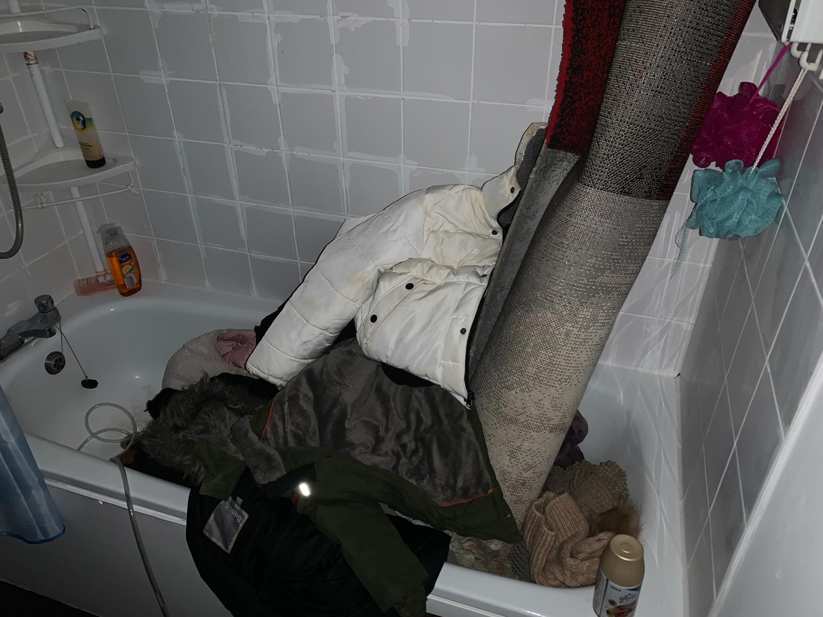 The family tried to salvage some of their belongings after their flat was flooded by putting them in the bath