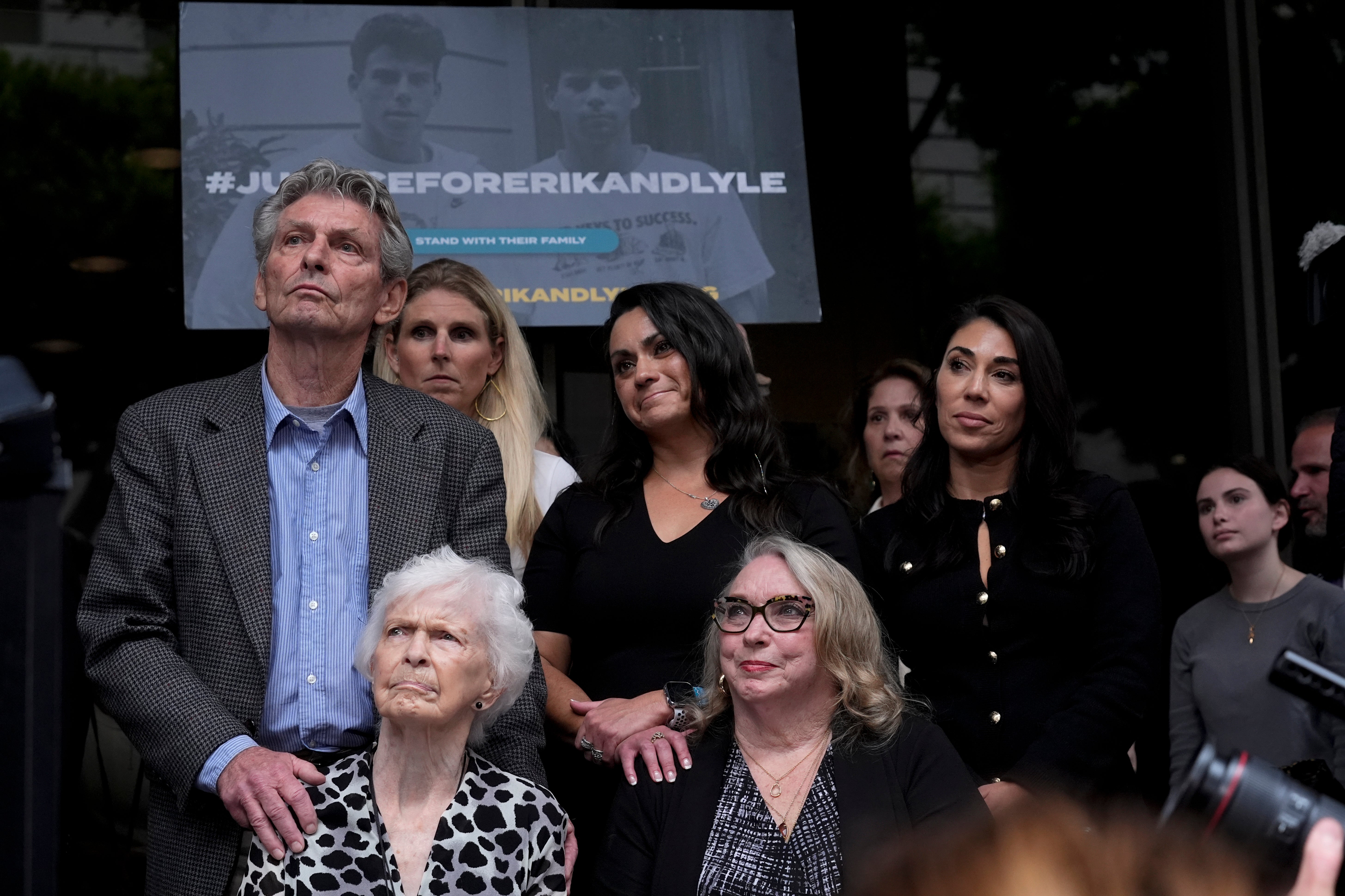 Kitty Menendez's sister, Joan Andersen VanderMolen, bottom left, and niece Karen VanderMolen, right, sit together during a press conference to announce developments on the case of brothers Erik and Lyle Menendez, in Los Angeles