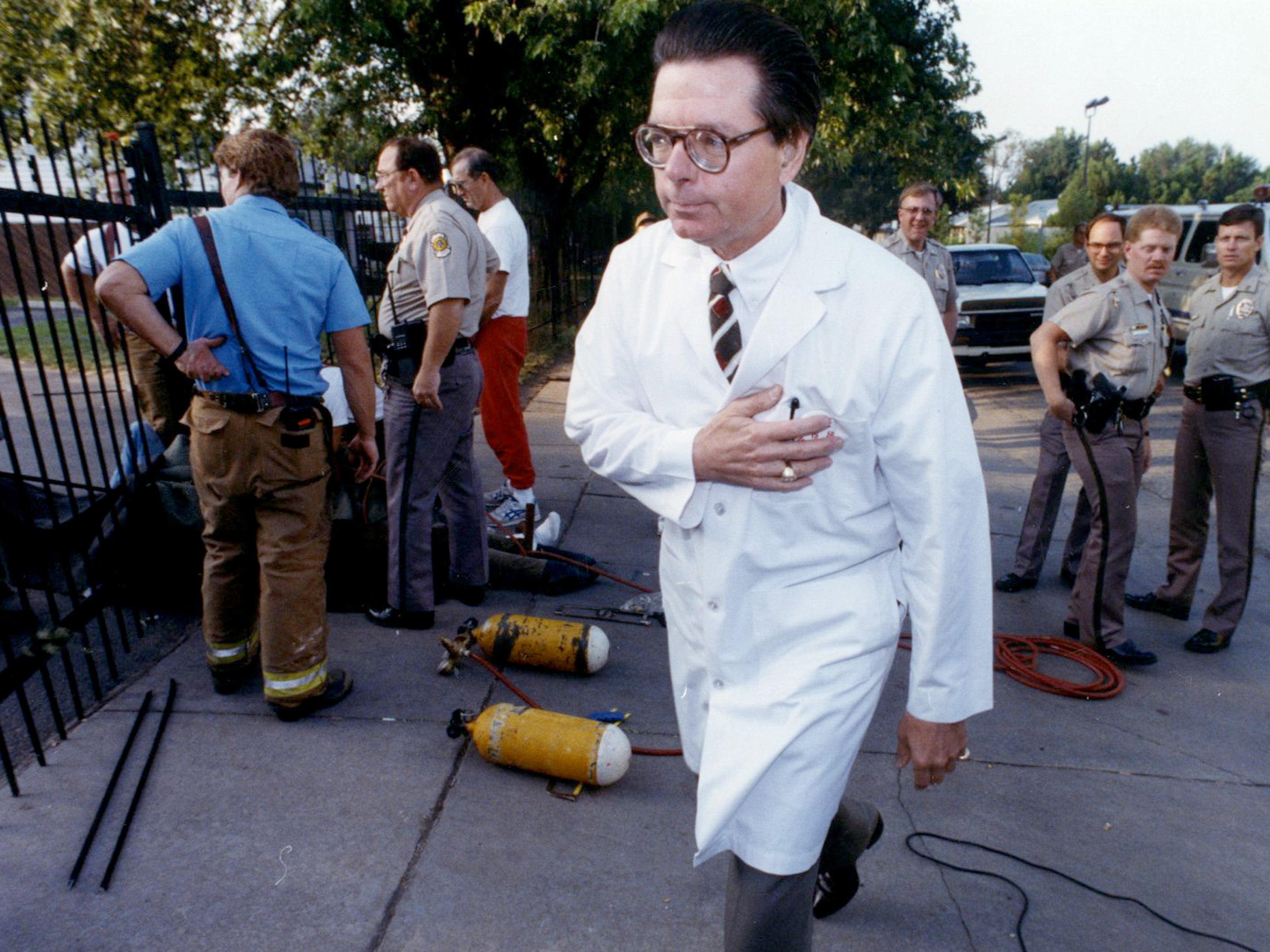 In this 1992 file photo, Dr George Tiller walks outside of his abortion clinic in Wichita, Kansas, after four people locked themselves to the entrance of the clinic’s gates.