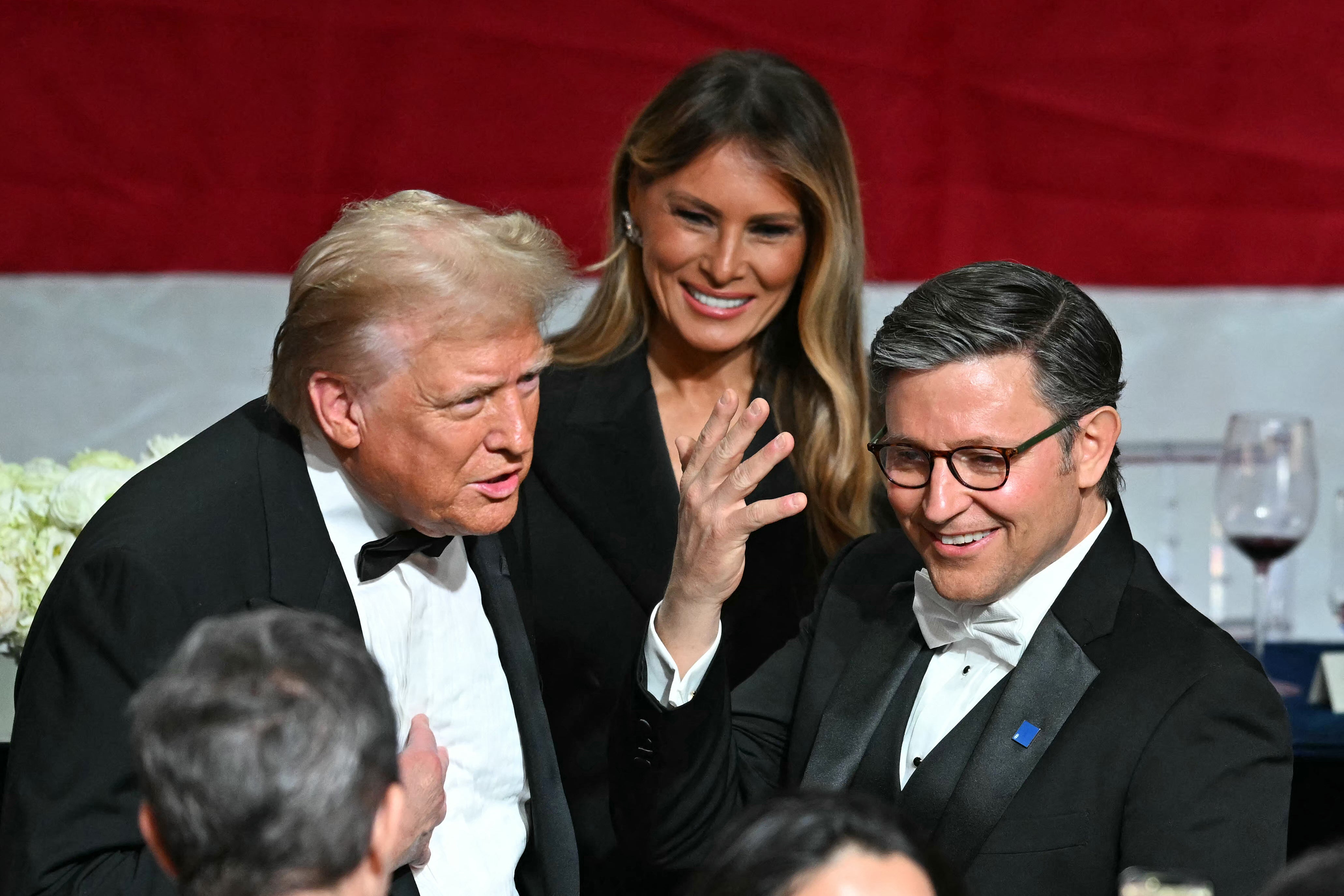 Republican presidential candidate Donald Trump (L) chats with Speaker of the House Mike Johnson (R) alongside former first lady Melania Trump during the 79th Annual Alfred E. Smith Memorial Foundation Dinner in New York City. Trump is again pitching no federal taxes, as GOP leaders in Congress prepare their own tax plans