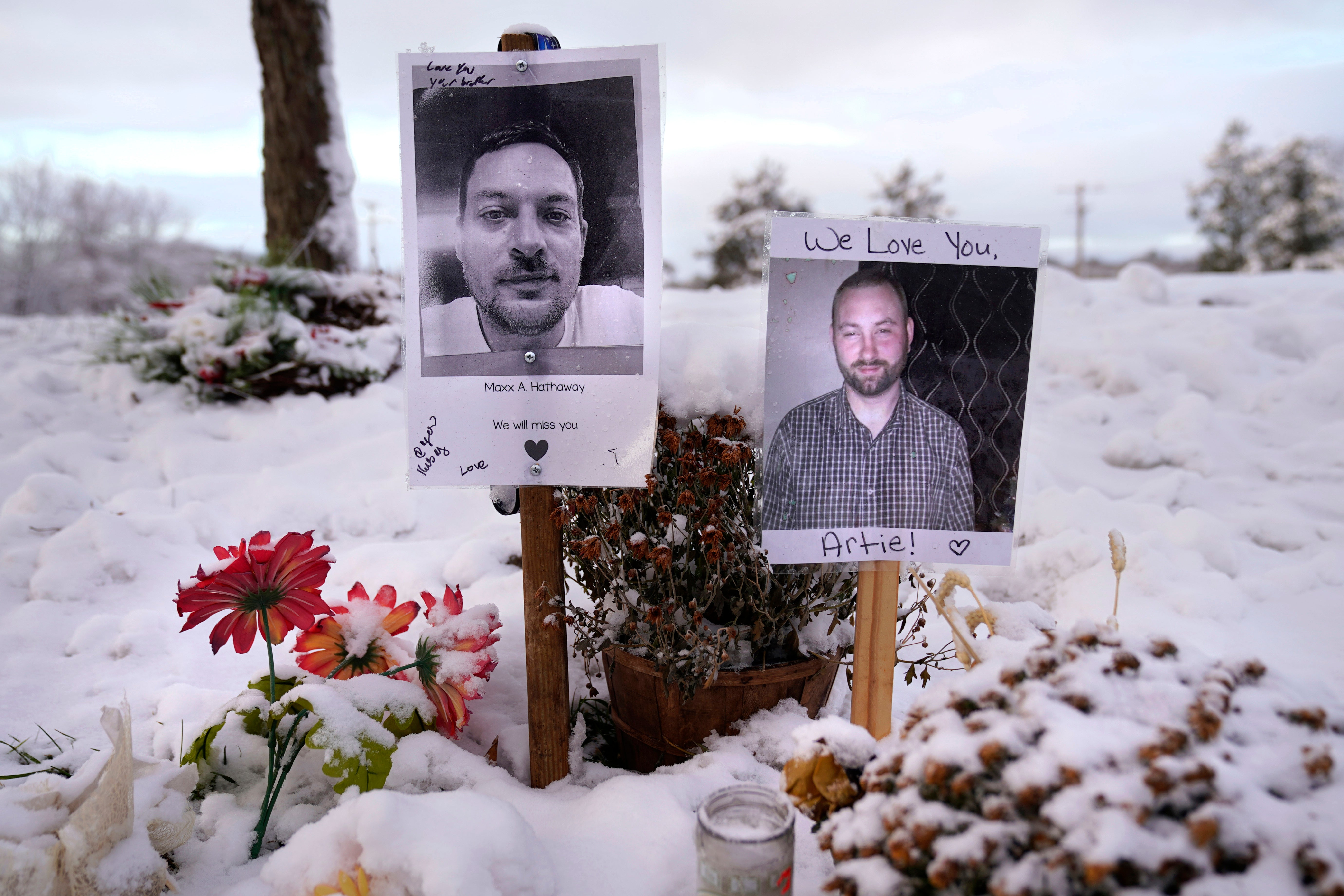 Pictures of two of the victims of the October 2023 mass shooting are seen at a makeshift memorial in Lewiston, Maine in December 2023