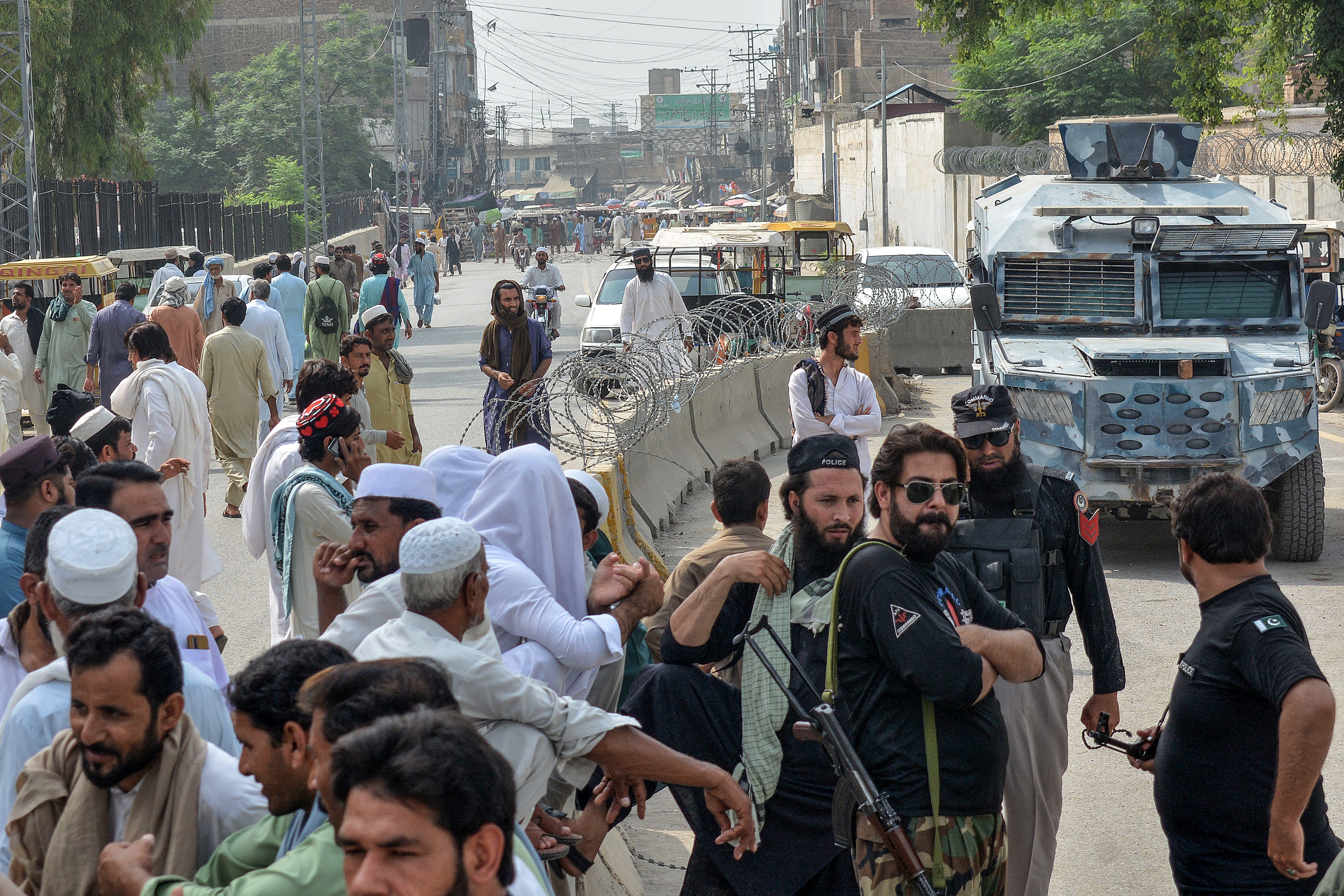 Security personnnel gather as they block a road in the northwestern border province of Khyber Pakhtunkhwa