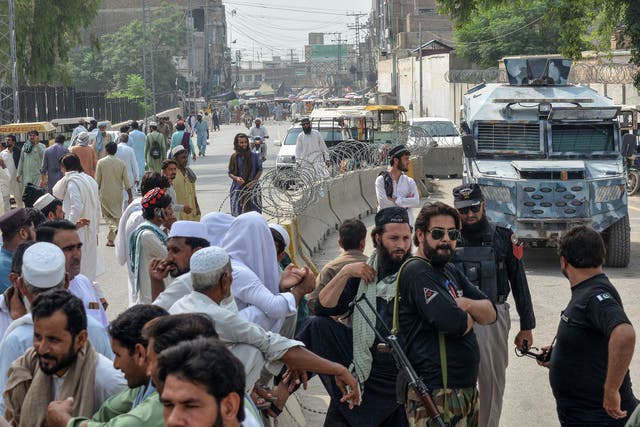 <p>Security personnnel gather as they block a road in the northwestern border province of Khyber Pakhtunkhwa</p>