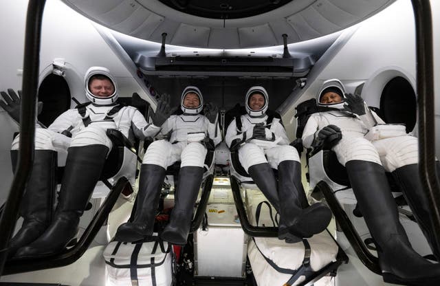 <p>Astronauts sit inside the SpaceX Dragon Endeavour spacecraft onboard the SpaceX recovery ship MEGAN shortly after having landed in the Gulf of Mexico Friday morning</p>