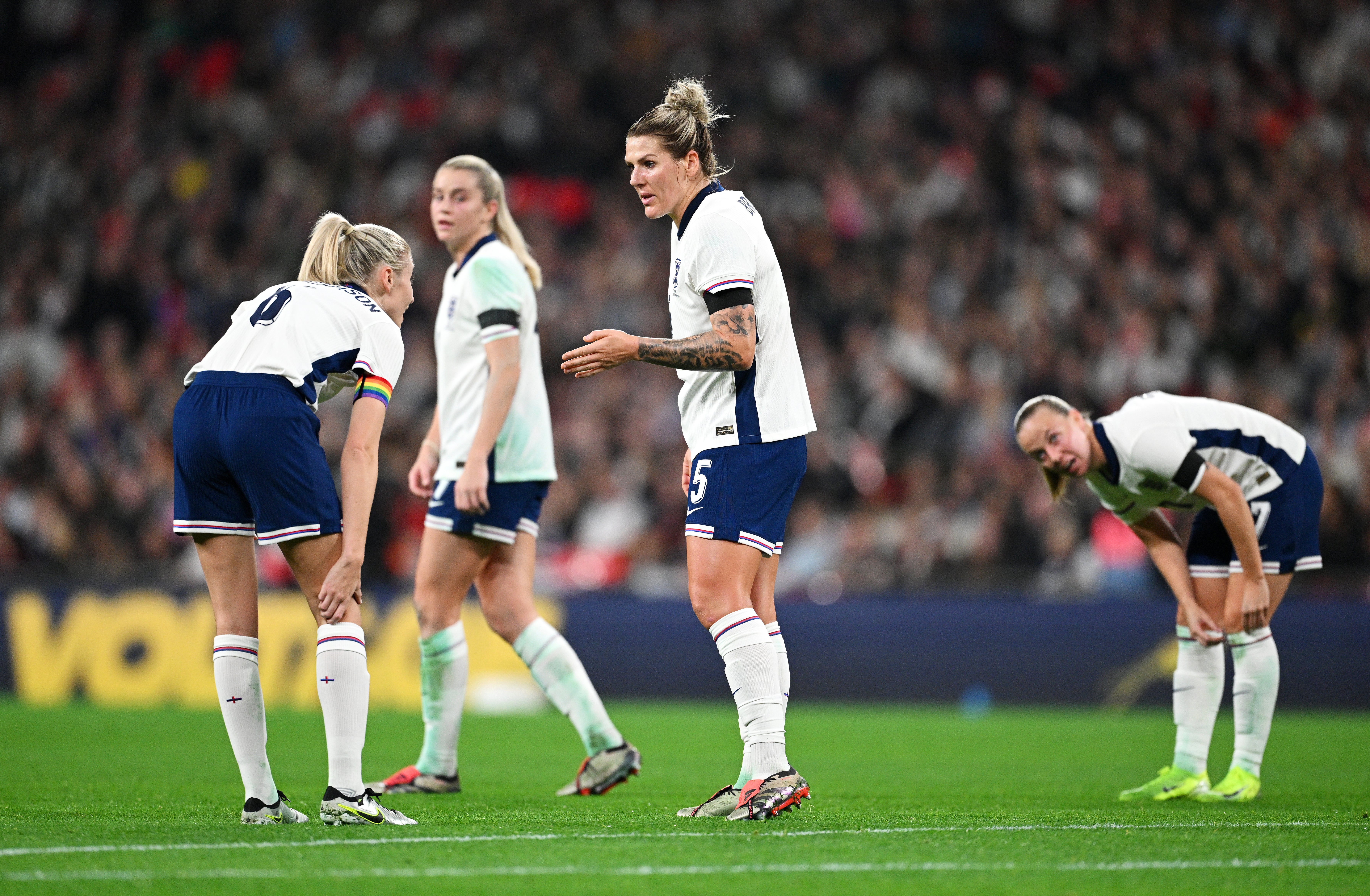 Millie Bright, centre, speaks to Leah Williamson after Klara Buhl of Germany scores her team’s third goal