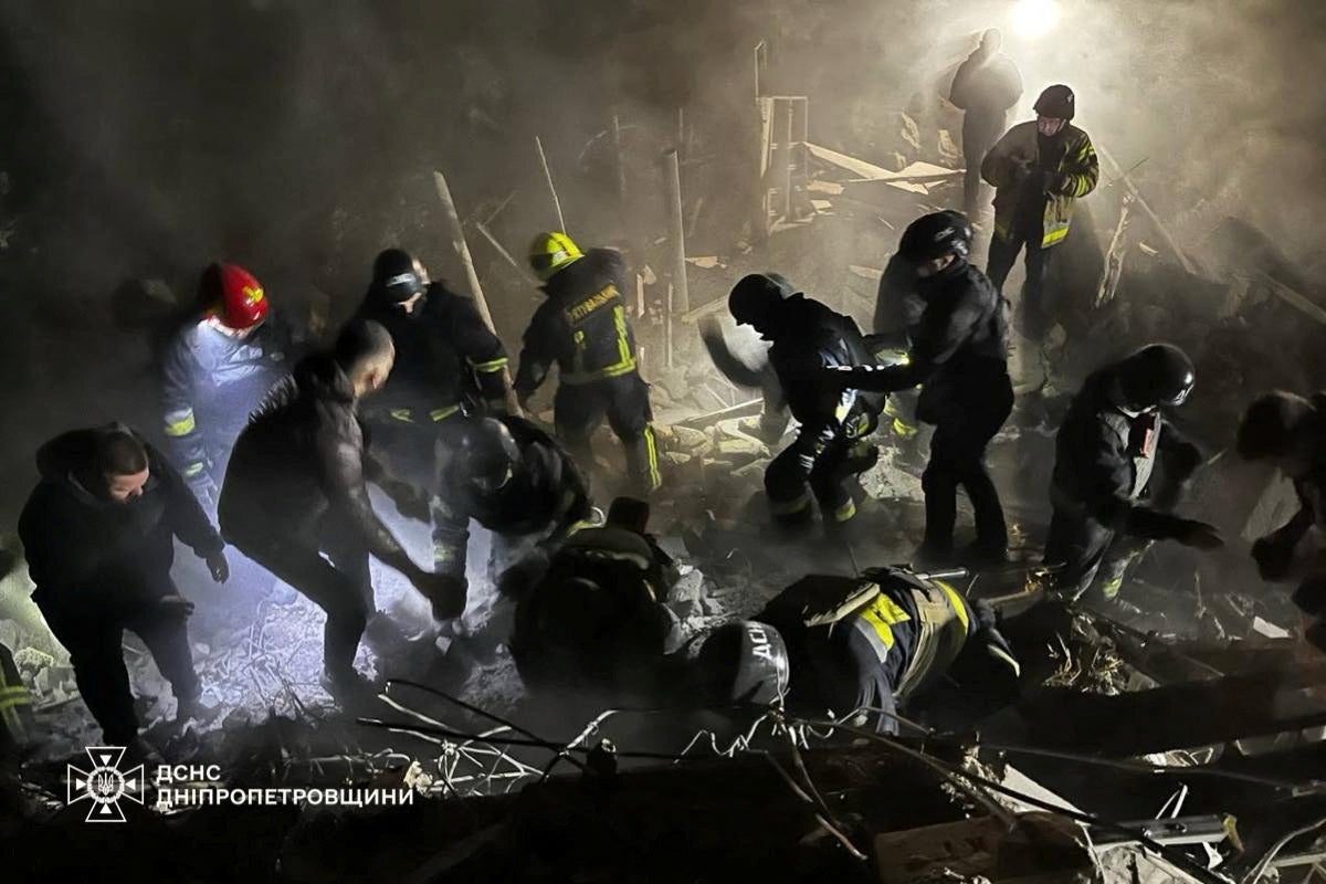 Rescuers work at a site of an apartment building destroyed by a Russian missile strike, in this handout picture released 26 October 2024