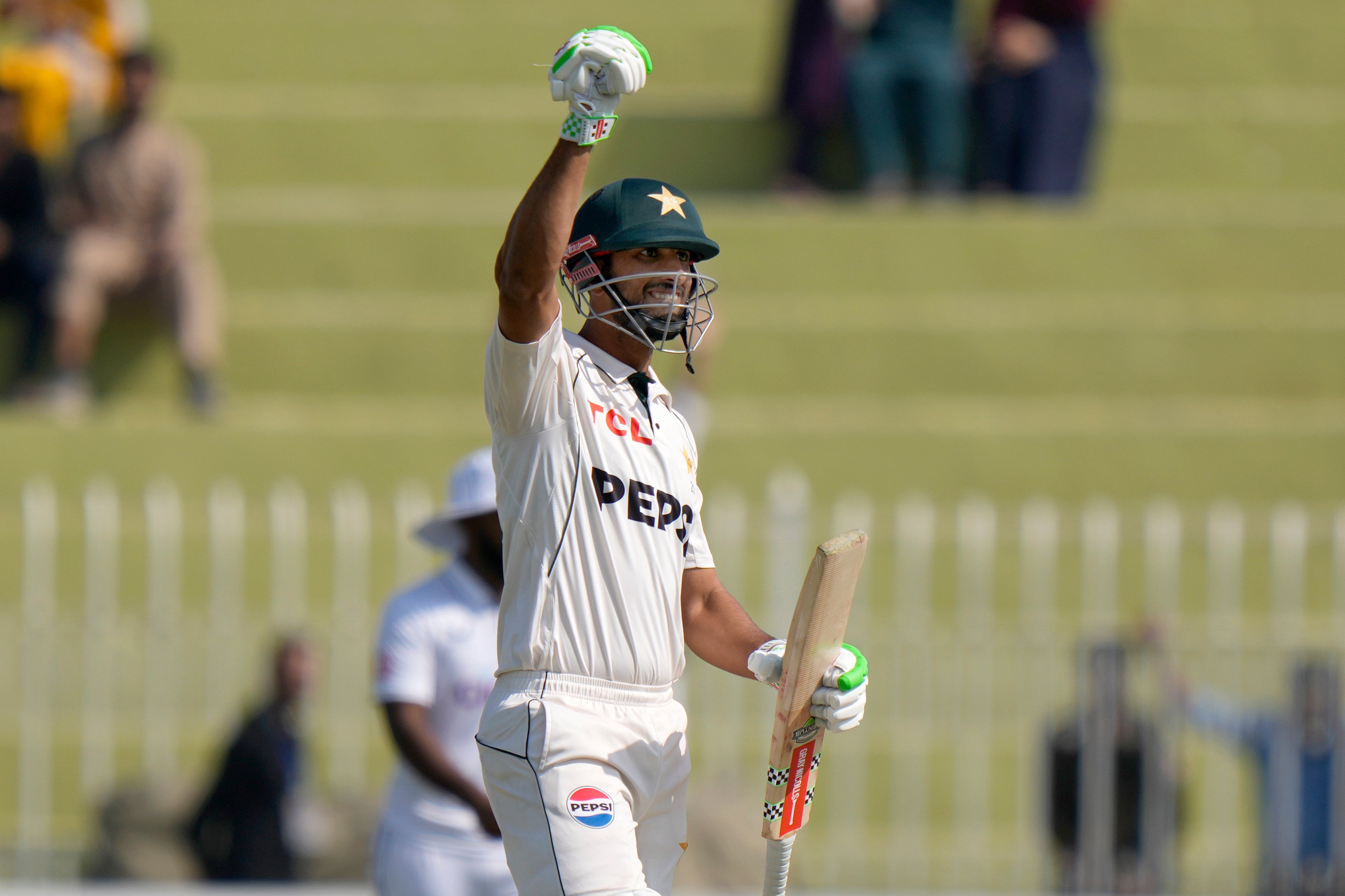 Pakistan captain Shan Masood celebrates his side’s victory (Anjum Naveed/AP)