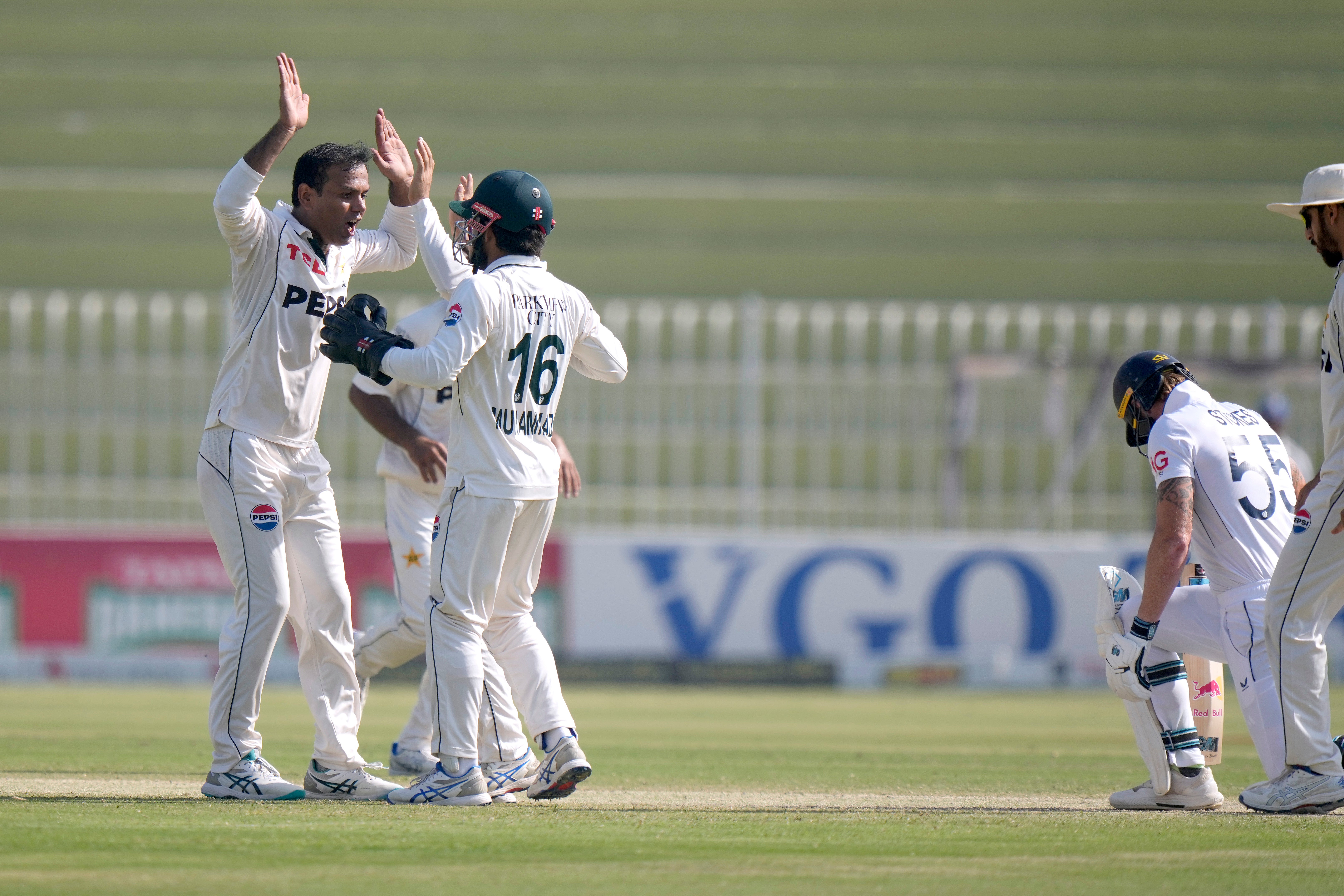 Pakistan’s Noman Ali celebrates with team-mates after trapping Ben Stokes lbw (Anjum Naveed/AP)