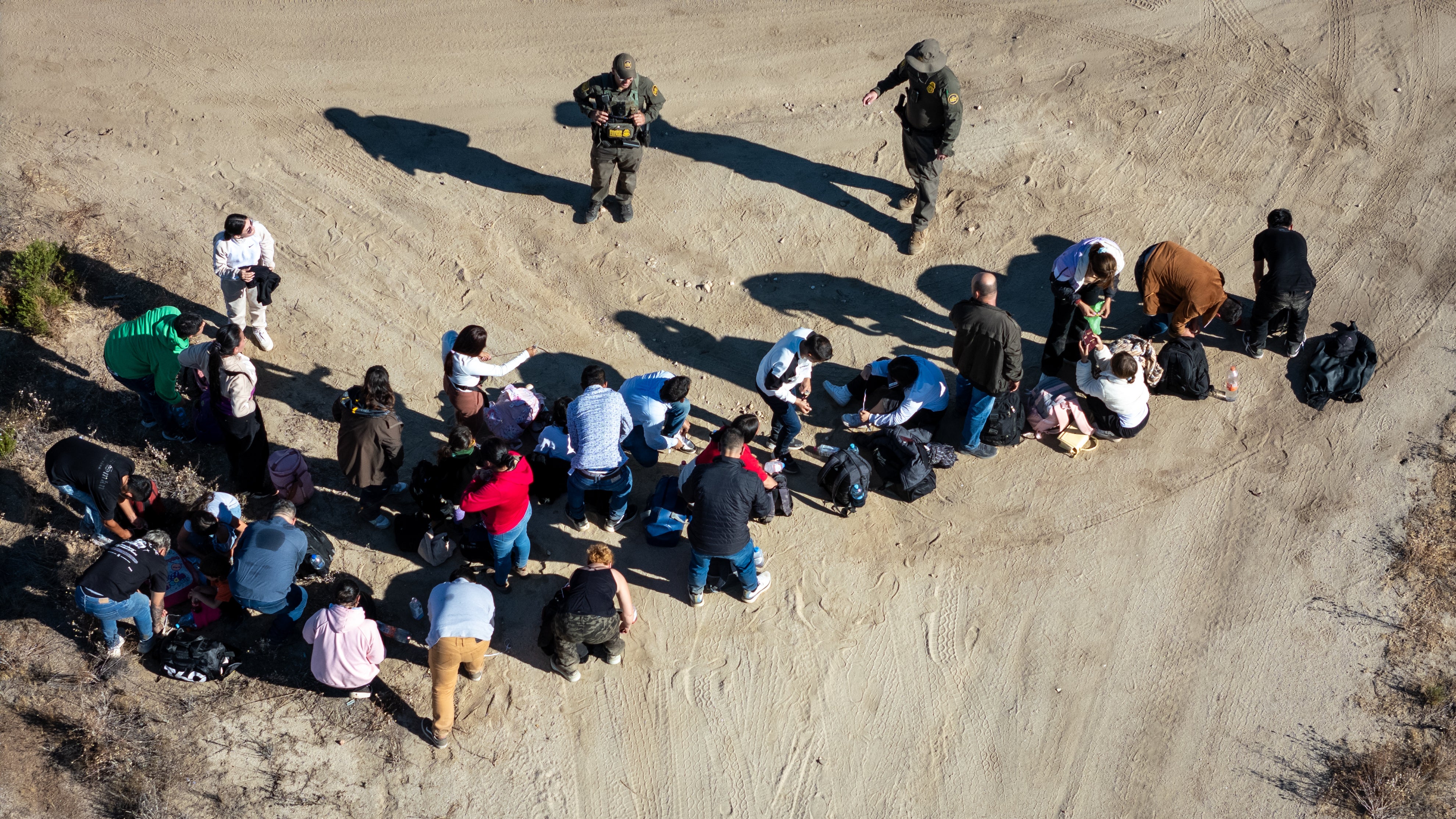 Representative: An aerial view of US Border Patrol agents fathering asylum seekers near Mexico border on 22 September 2024