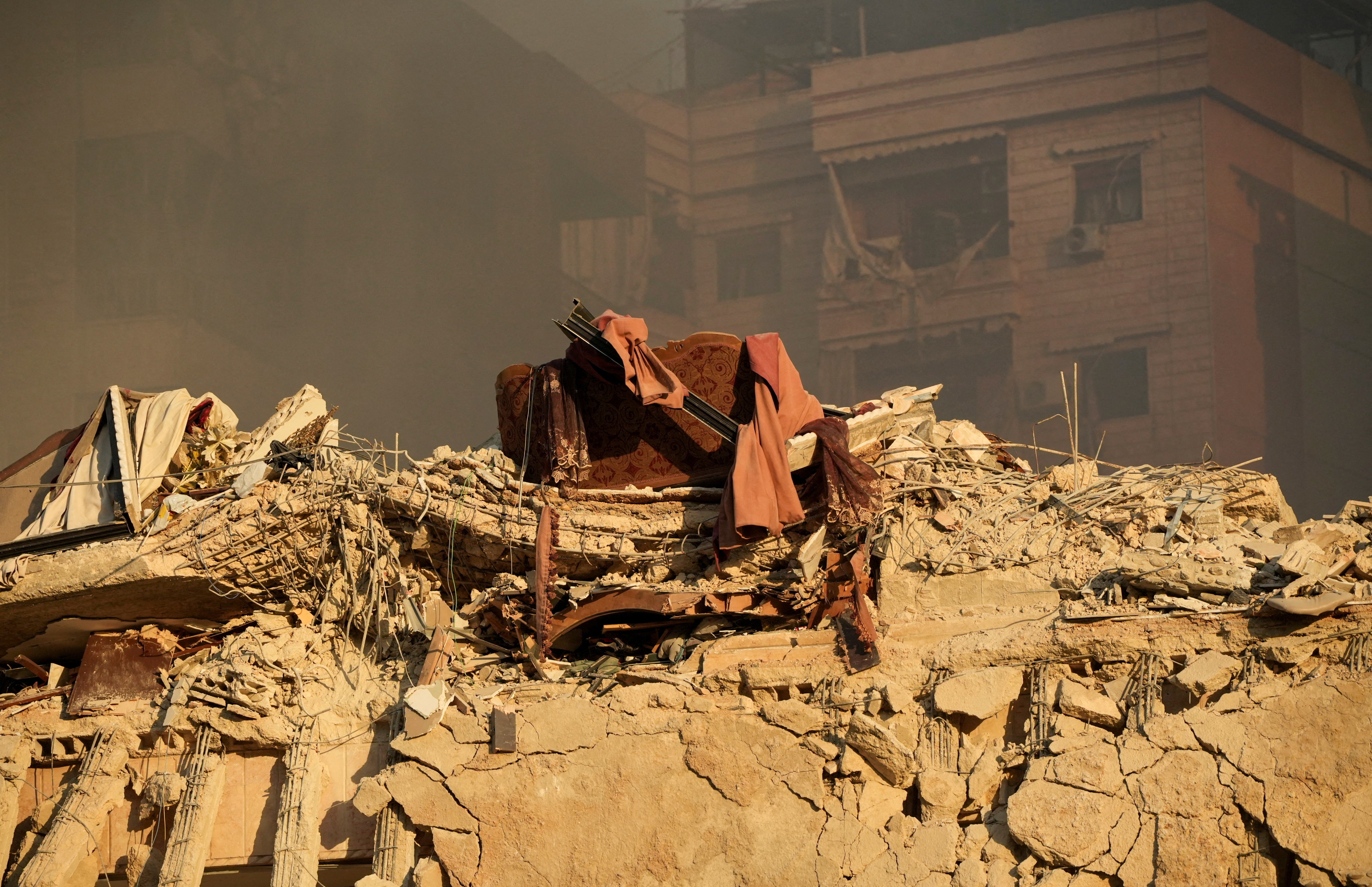 Furniture sits on the rubble of a building damaged in the aftermath of Israeli strikes on Beirut’s southern suburbs, Lebanon