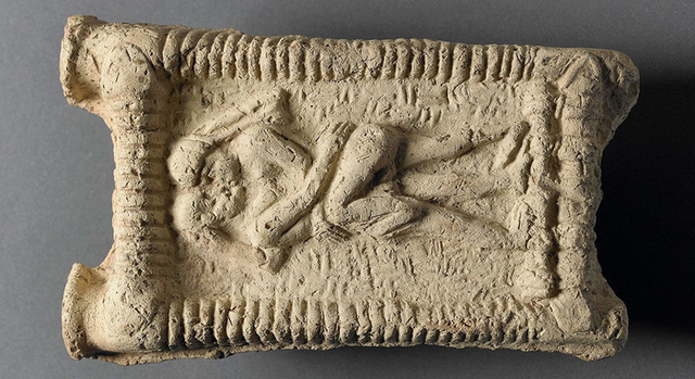 <p>Babylonian clay model showing couple on couch engaged in sex and kissing</p>