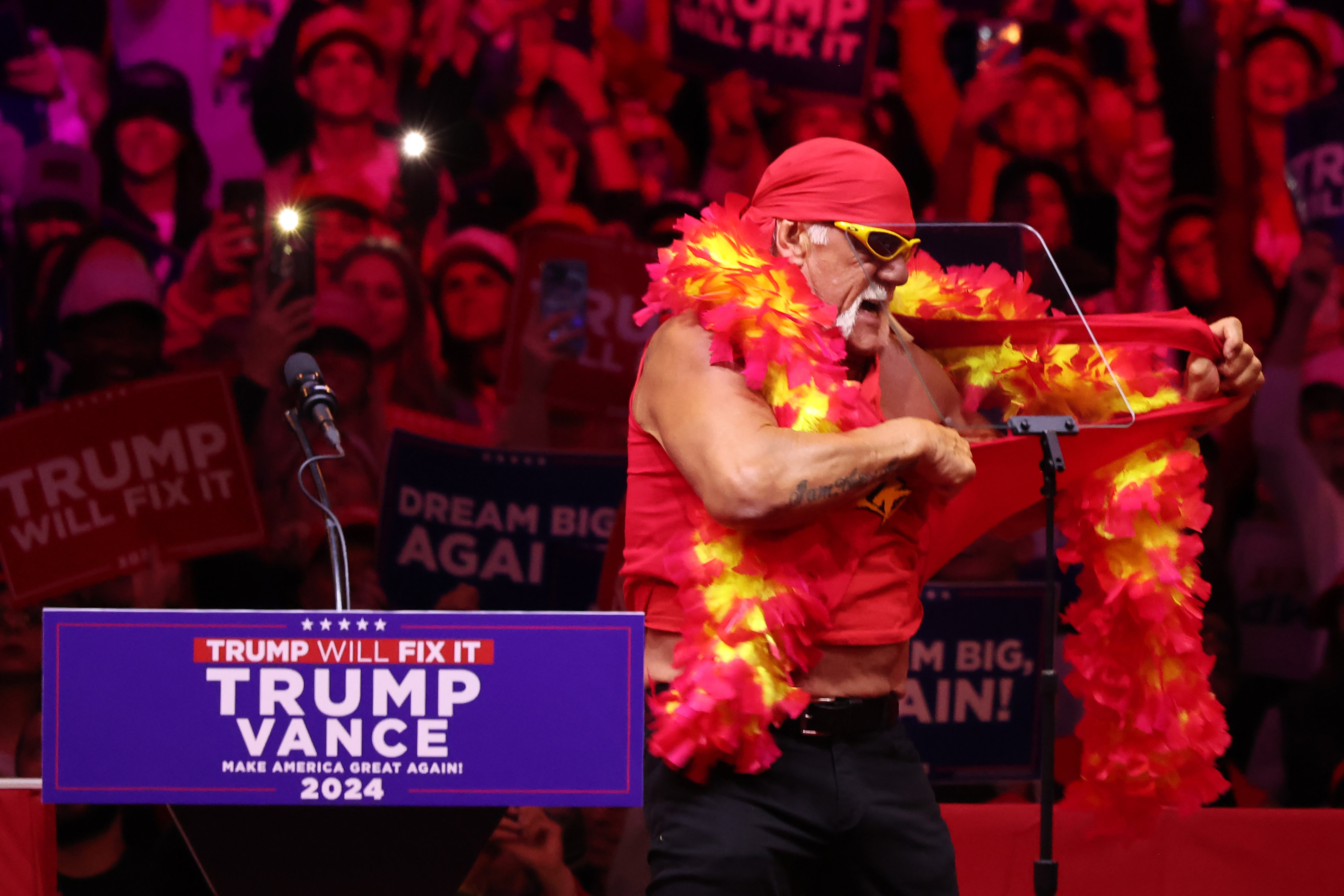 Former WWE wrestler Hulk Hogan rips off his shirt during a campaign rally for Donald Trump