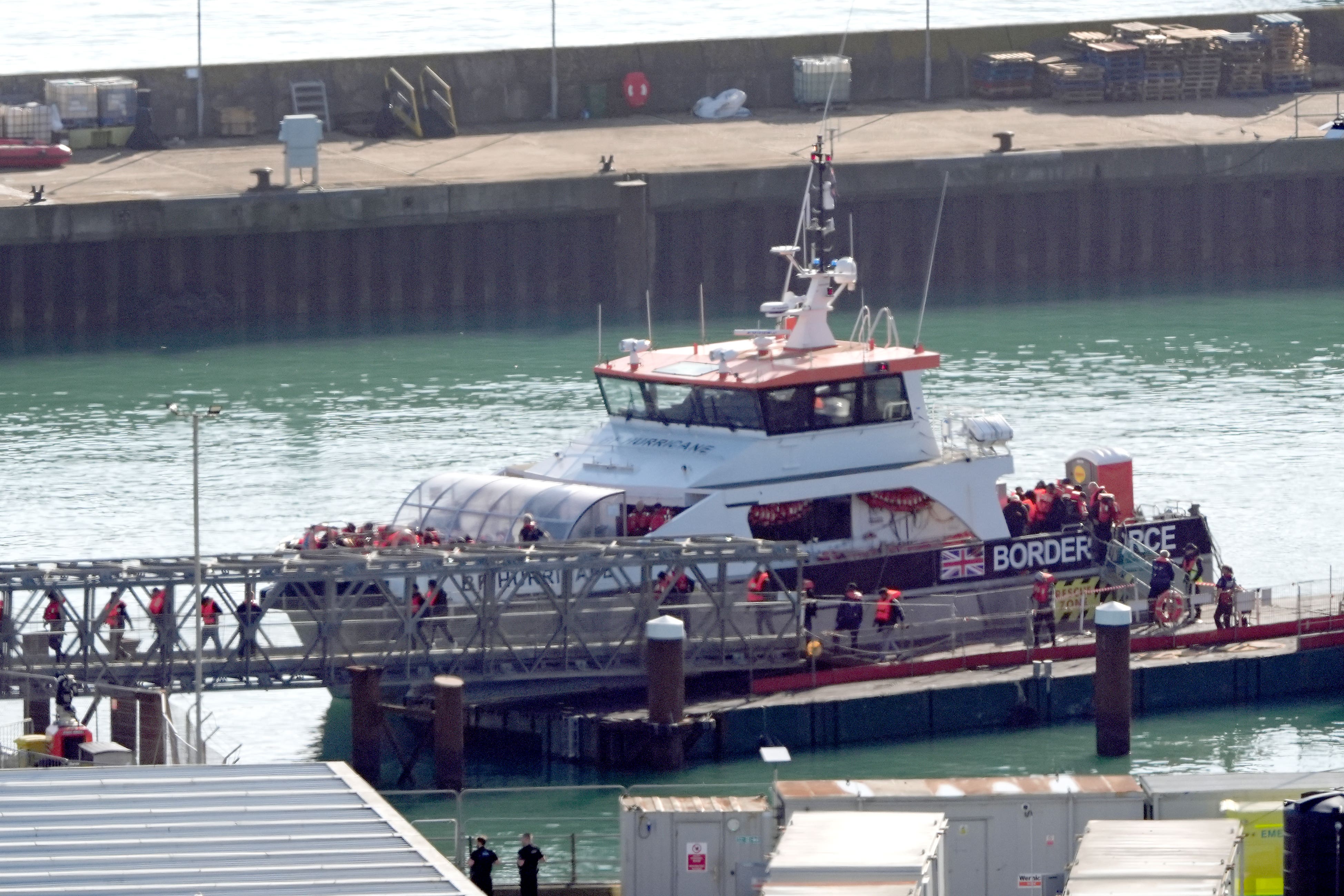 A group of people thought to be migrants are taken in to Dover (Gareth Fuller/PA)