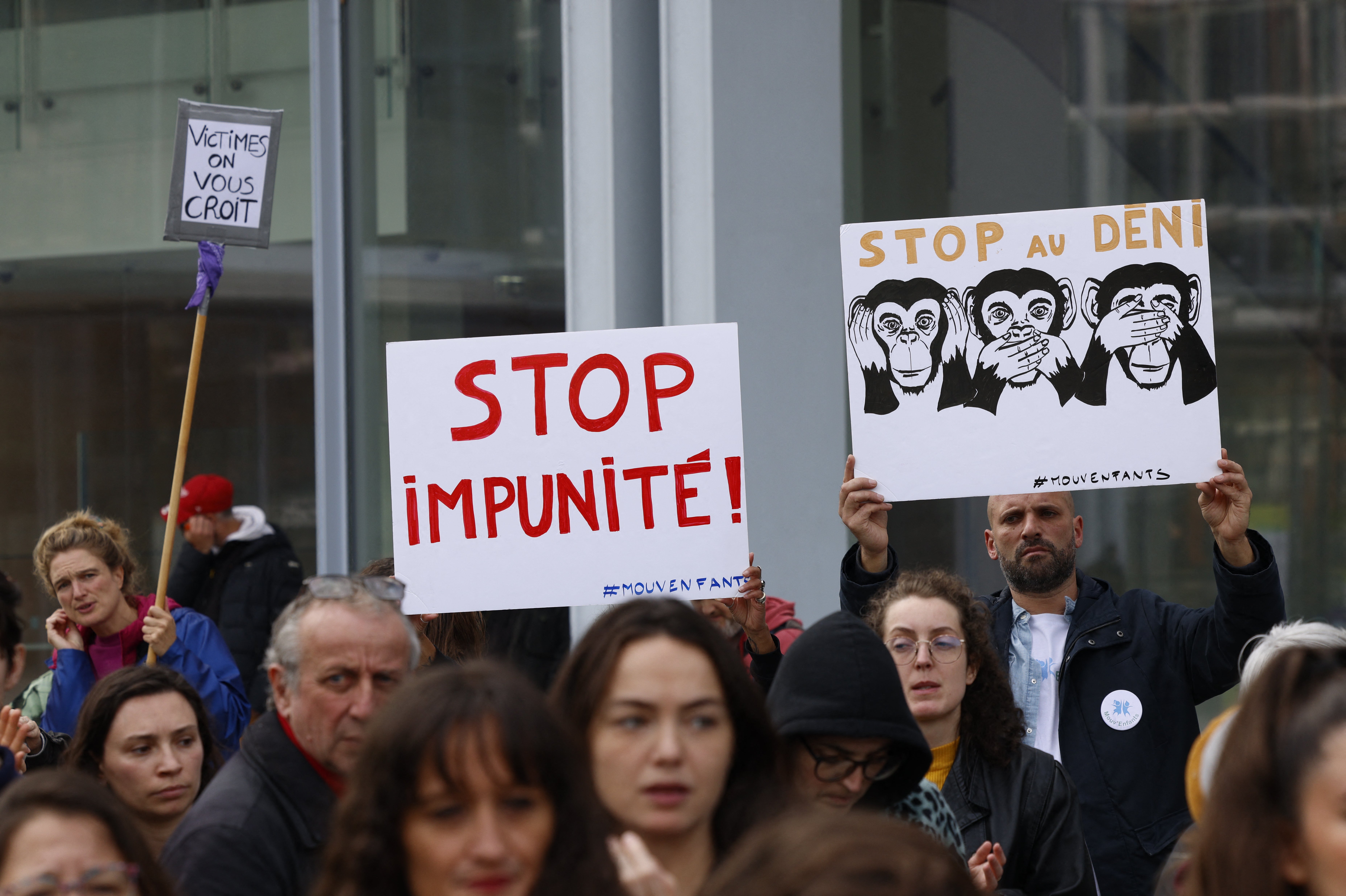 Protestors outside the court with placards demanding an end to impunity for sexual assaults