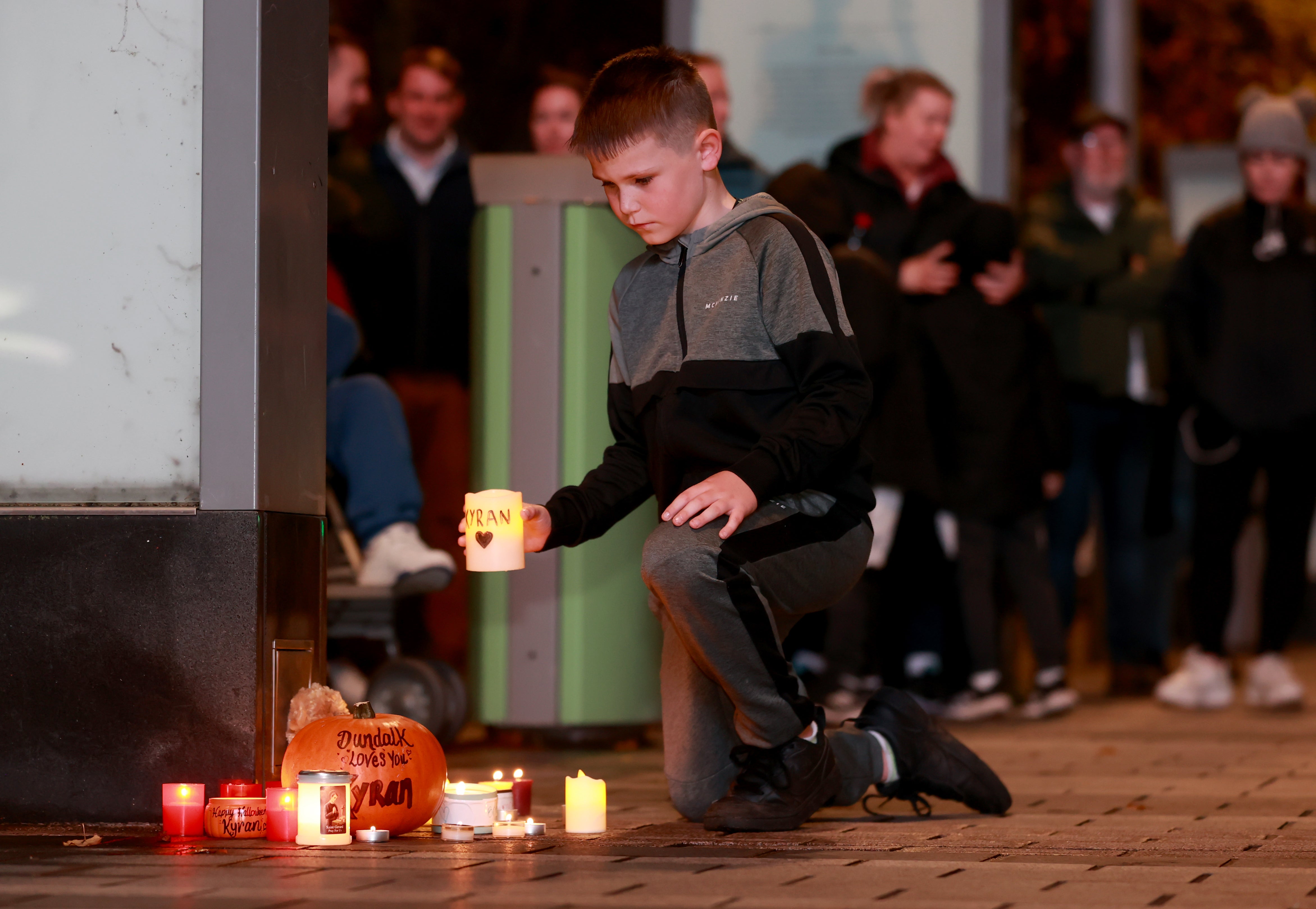 Candles being placed among other tributes at a vigil for Kyran Durnin in Market Square, Dundalk