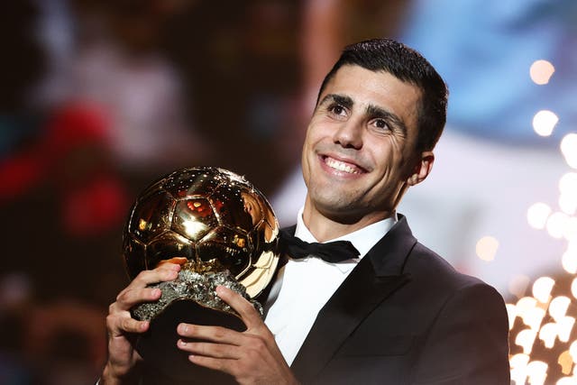 <p>Rodri poses with the trophy after winning the Ballon d’Or </p>