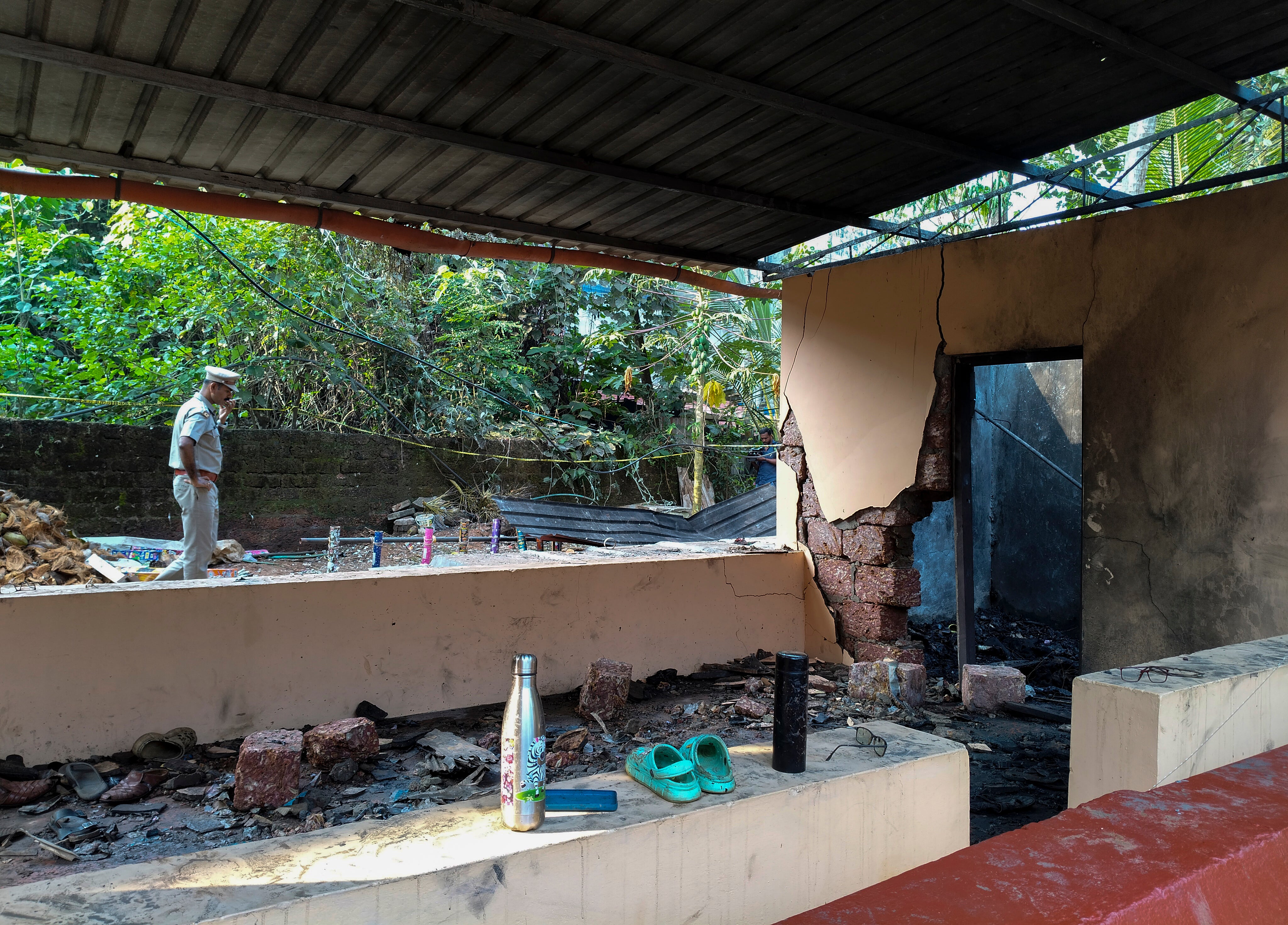 A police officer at the scene of the fireworks explosion at a temple in Kerala, India