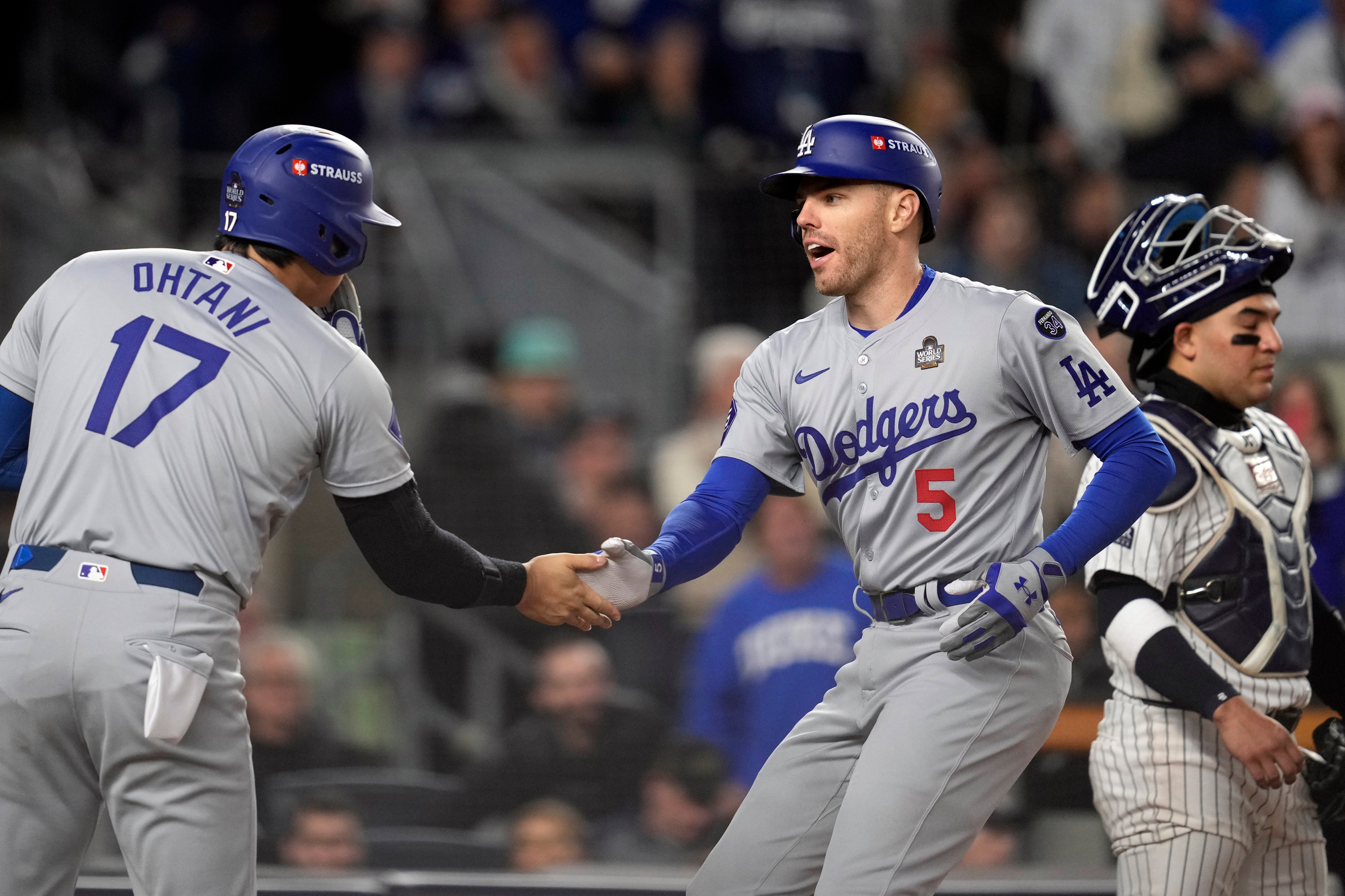 Shohei Ohtani celebrated with Freddie Freeman after the latter’s home run helped put the LA Dodgers a game away from World Series glory