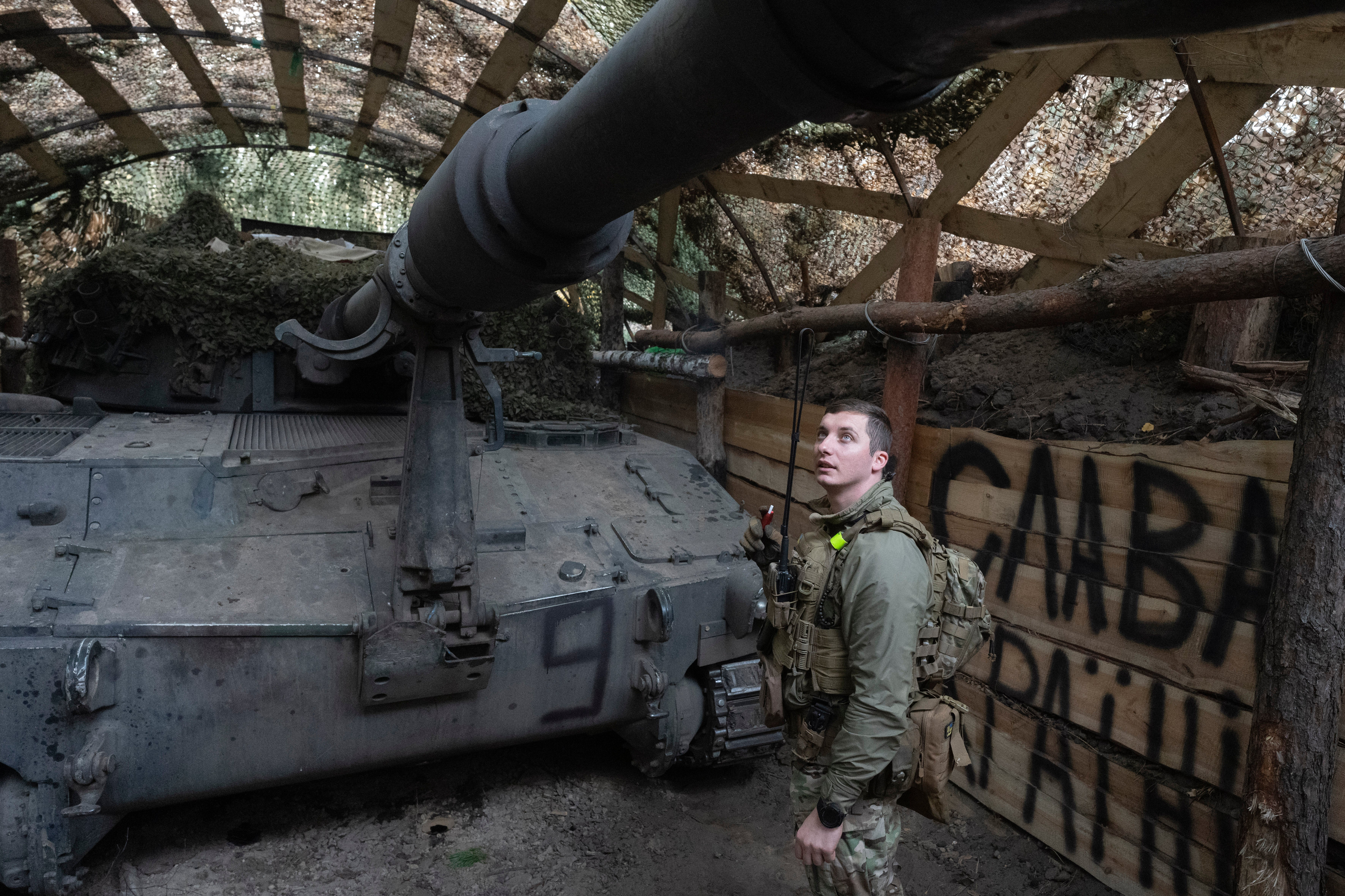 Ukrainian officer of the 92nd separate assault brigade inspects 155mm M-109 “Paladin” howitzer on the frontline near Vovchansk