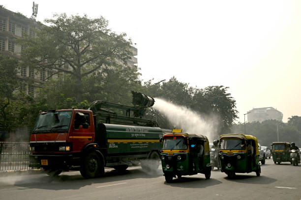 A vehicle of the Public Works Department sprays water with an anti-smog gun to curb air pollution in New Delhi