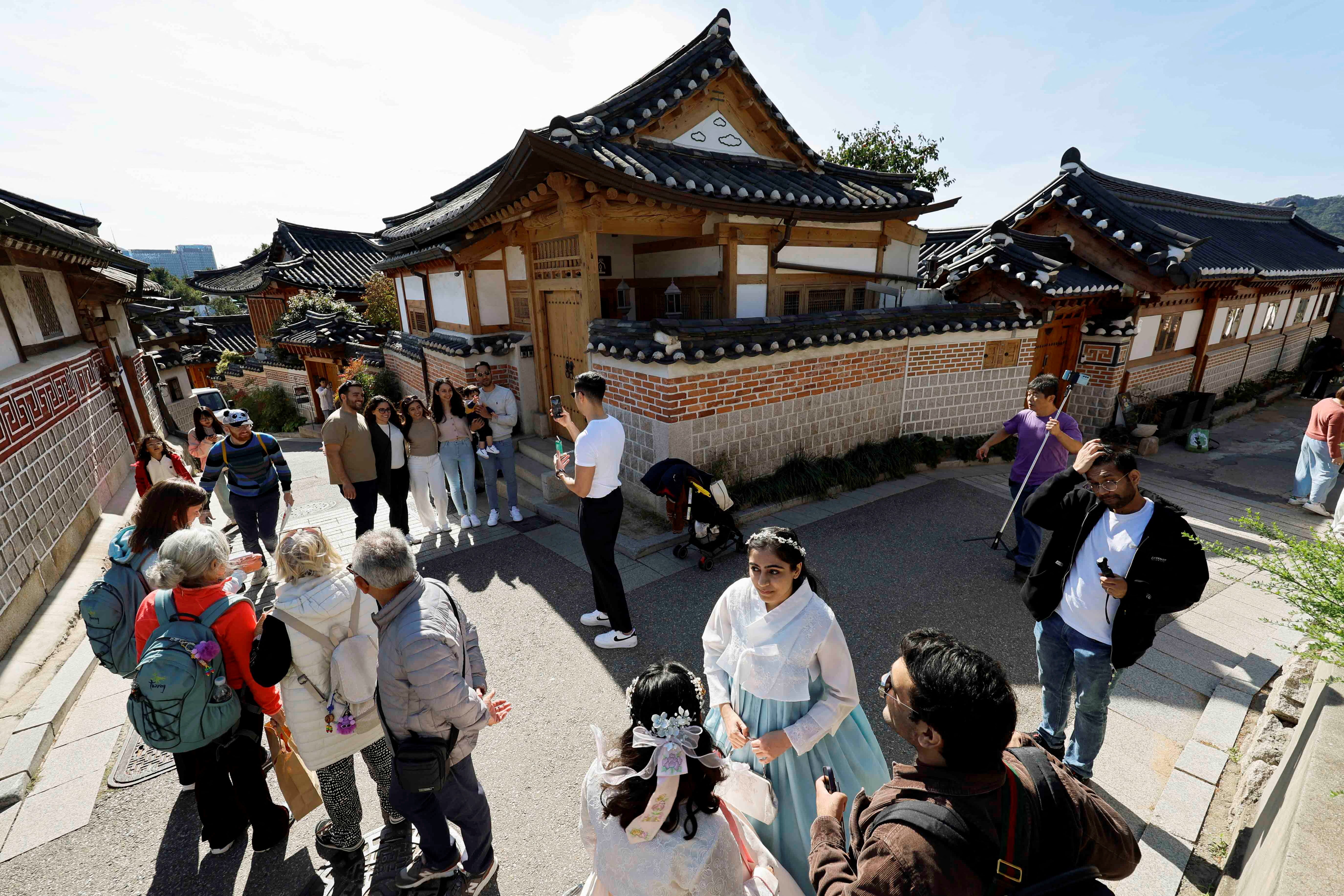 Tourists gather and interact at Bukchon Hanok Village in Seoul, South Korea