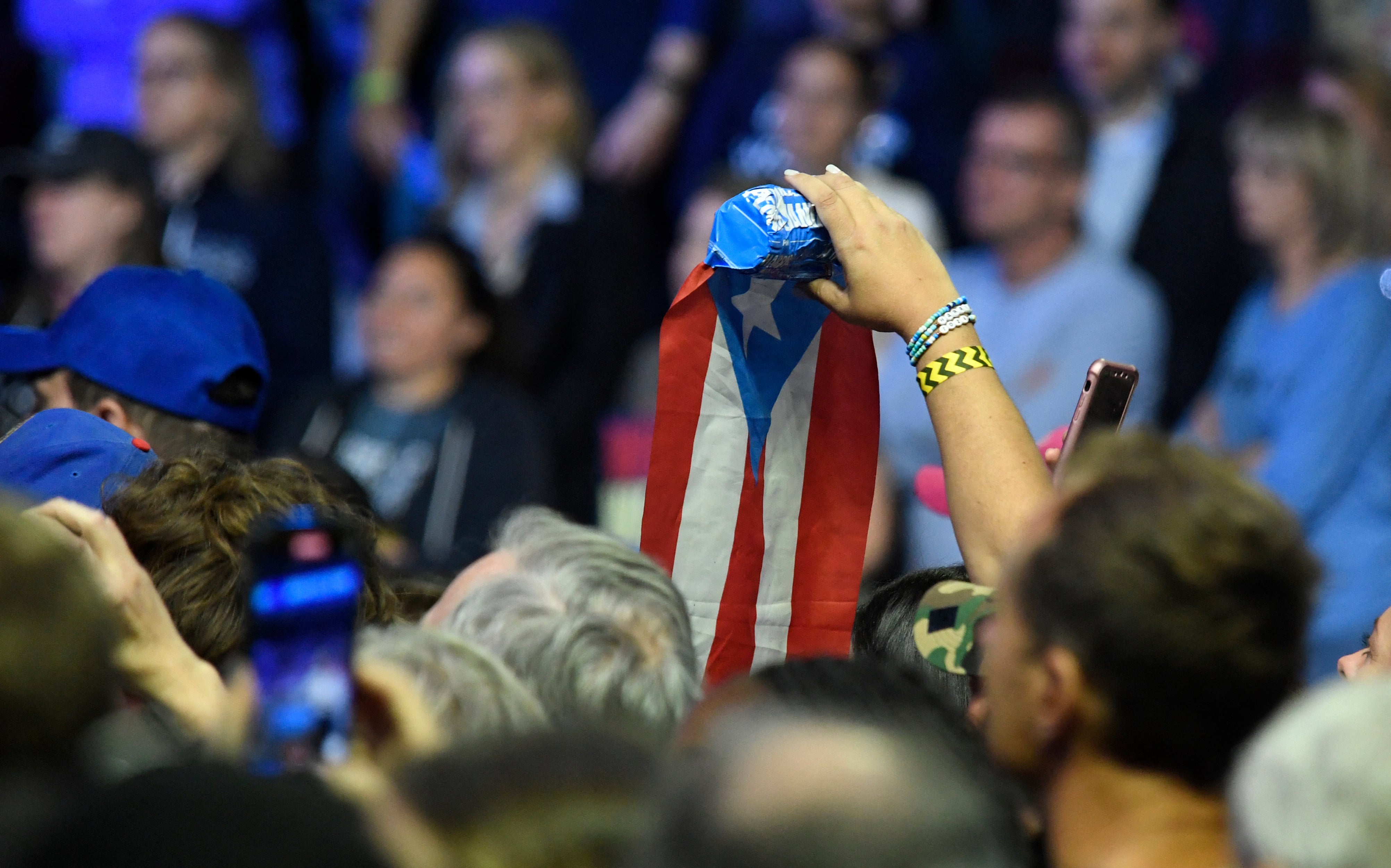 An attendee holds a Puerto Rico flag while Barack Obama speaks during a campaign event in support of Kamala Harris in Philadelphia on October 28.