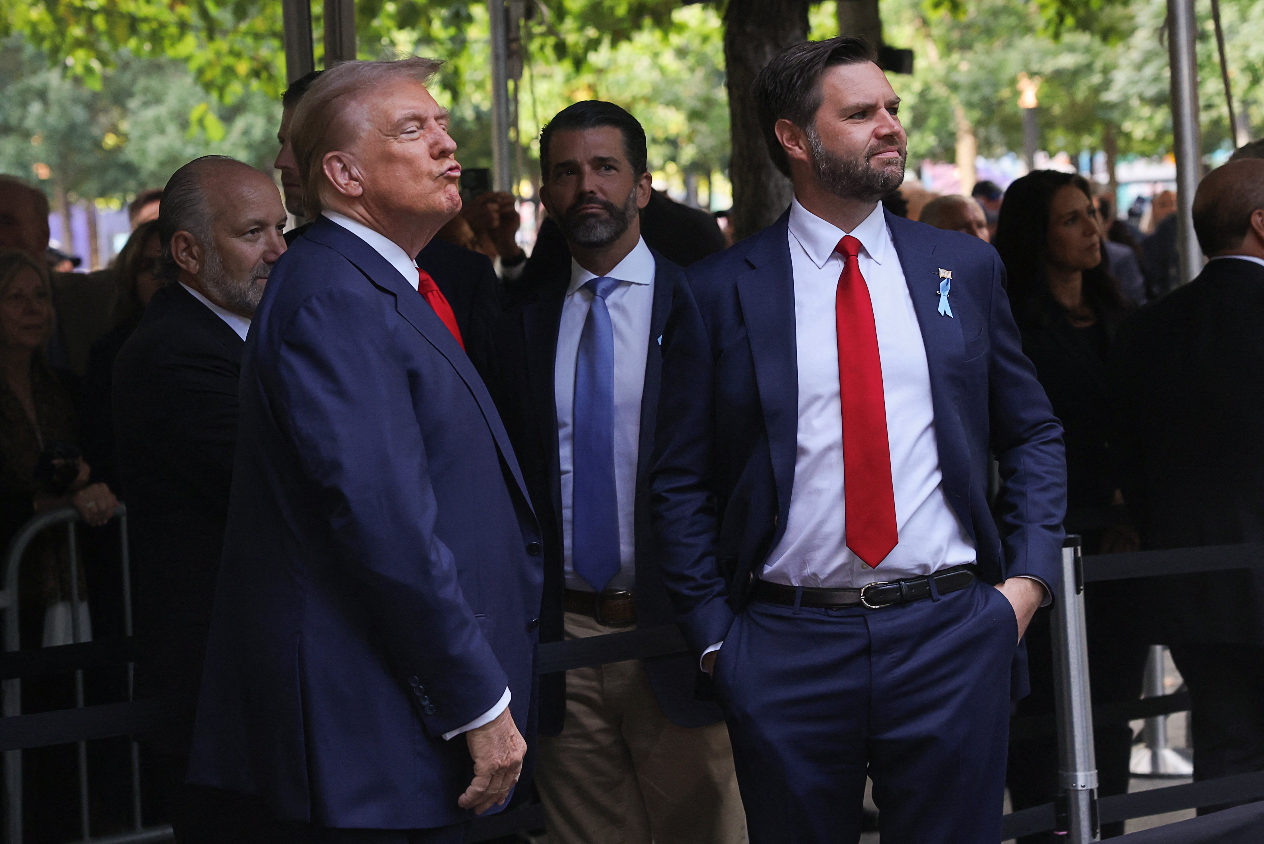 Trump Jr stands between his father and his friend and vice president, JD Vance