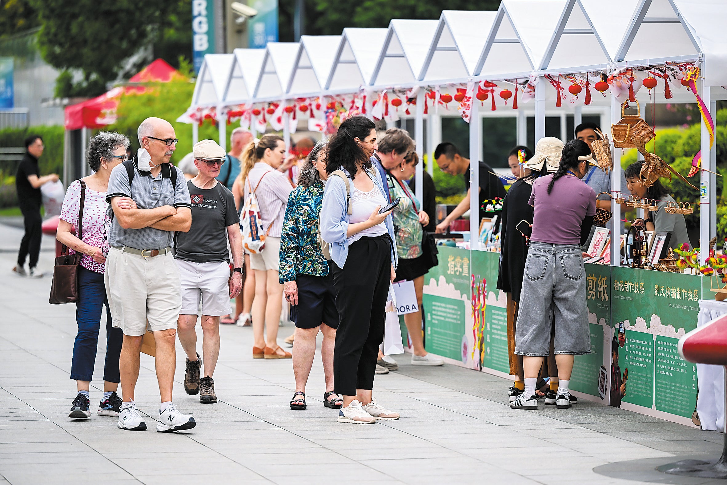 Visitors browse a market in Shanghai in September