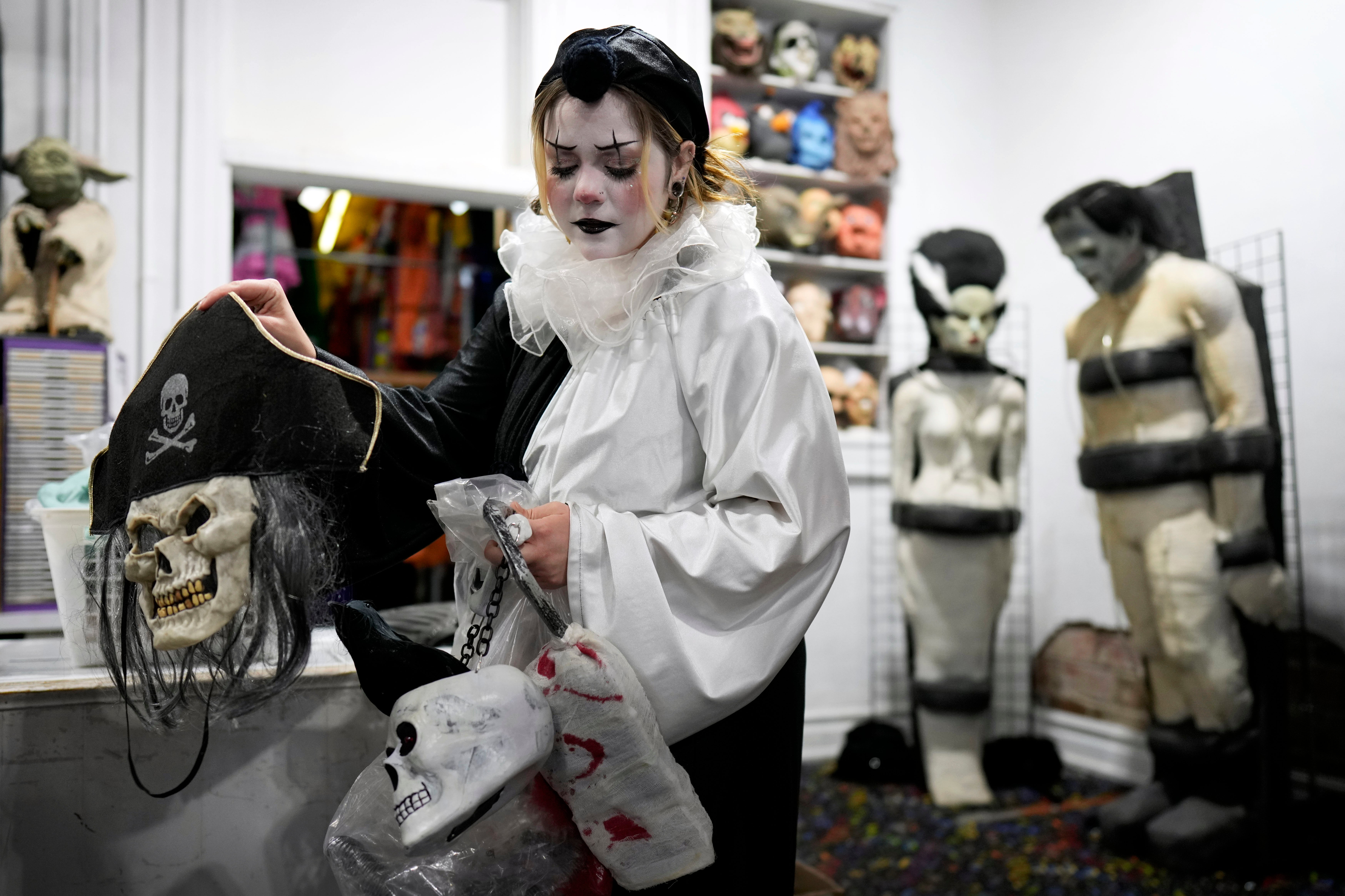 Olive Luther prepares to stock costume displays at The Theatrical Shop