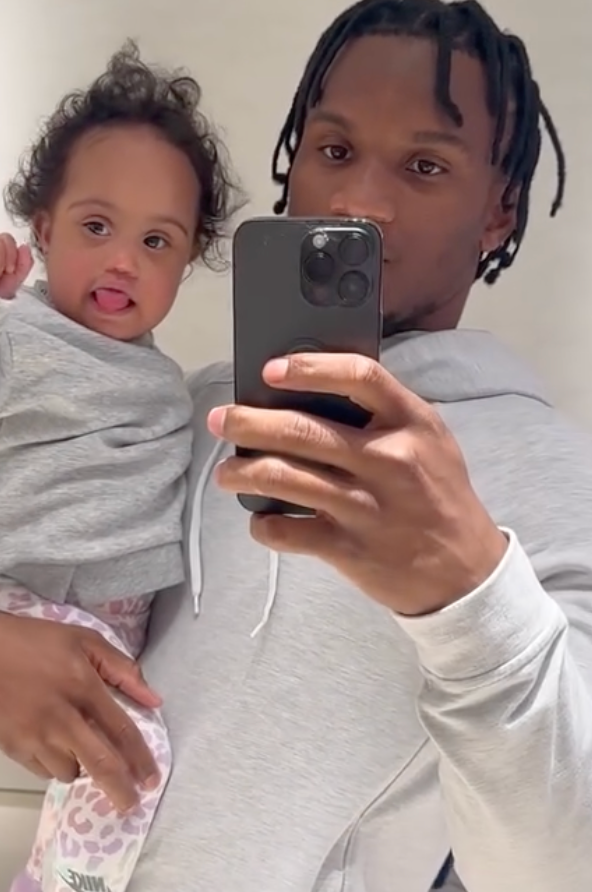 Charvarius Ward taking a video with his daughter Amani, who died at 23 months old