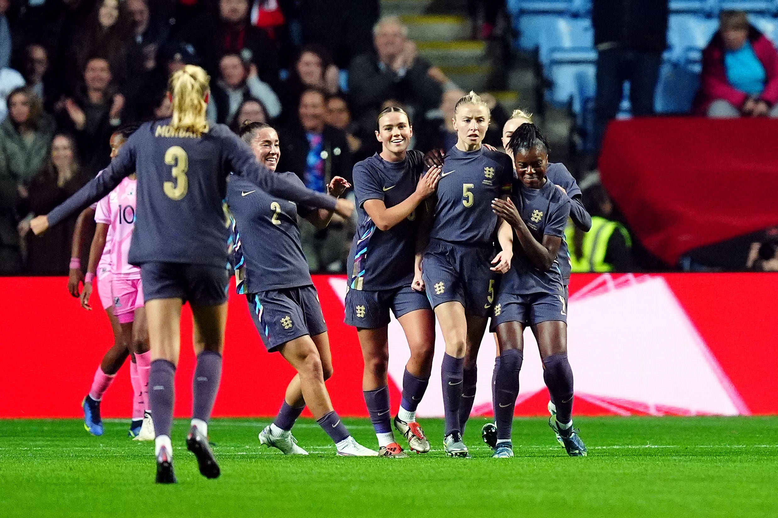 Leah Williamson, second right, celebrates the opener on her 50th cap