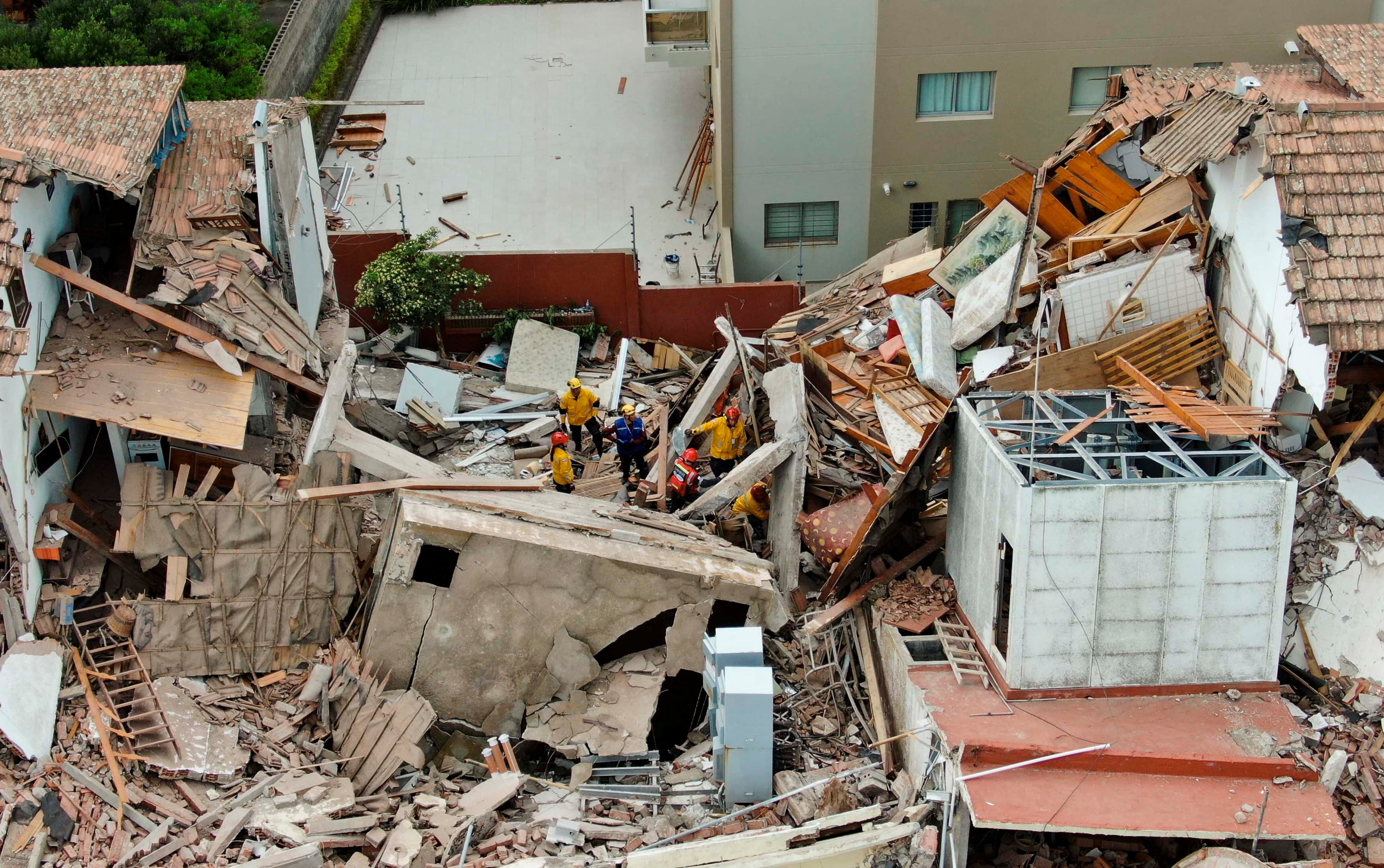 Firefighters search for trapped people after a hotel collapses in Villa Gesell