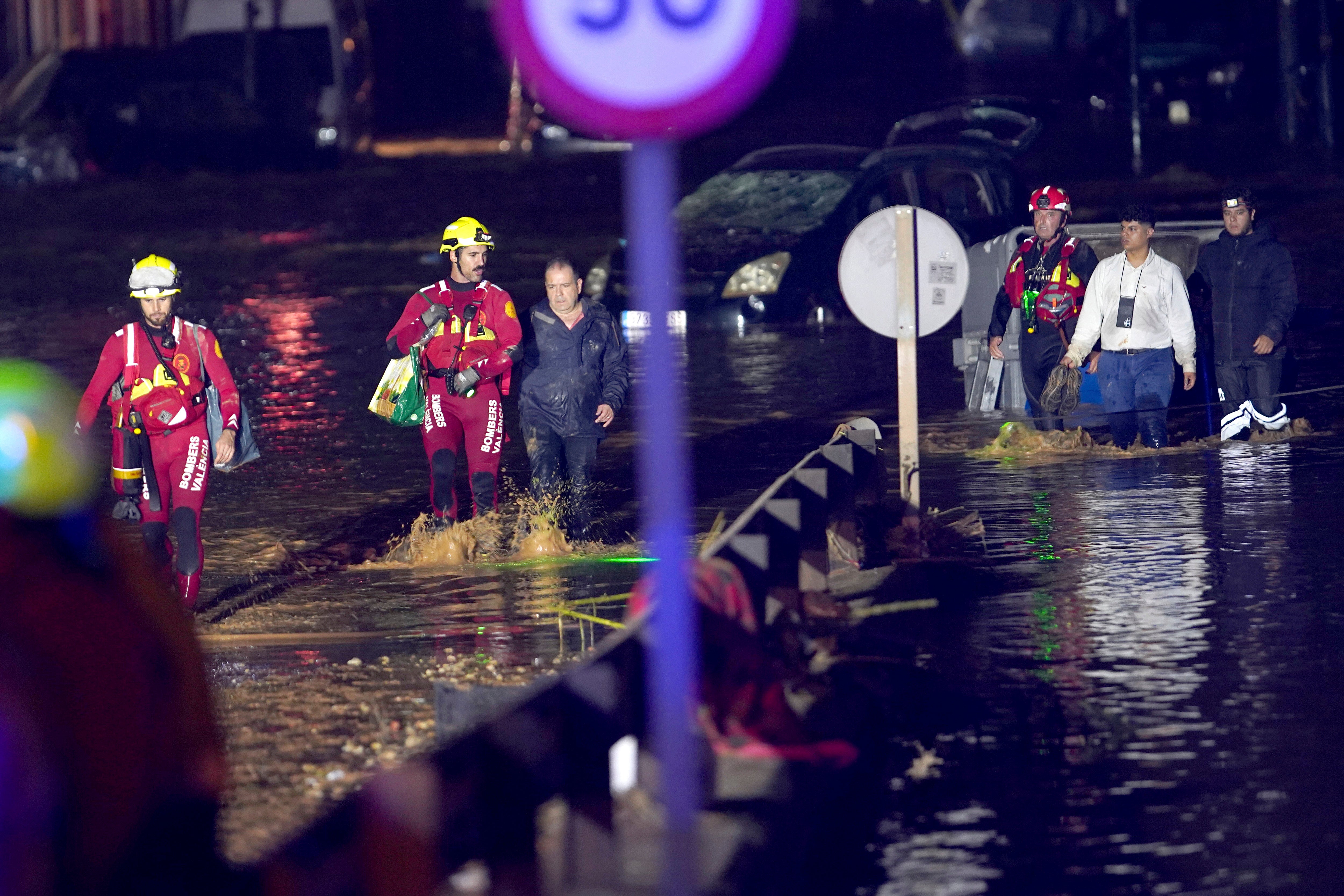 Emergency crew rescue residents after they were trapped in their homes following flooding in Valencia