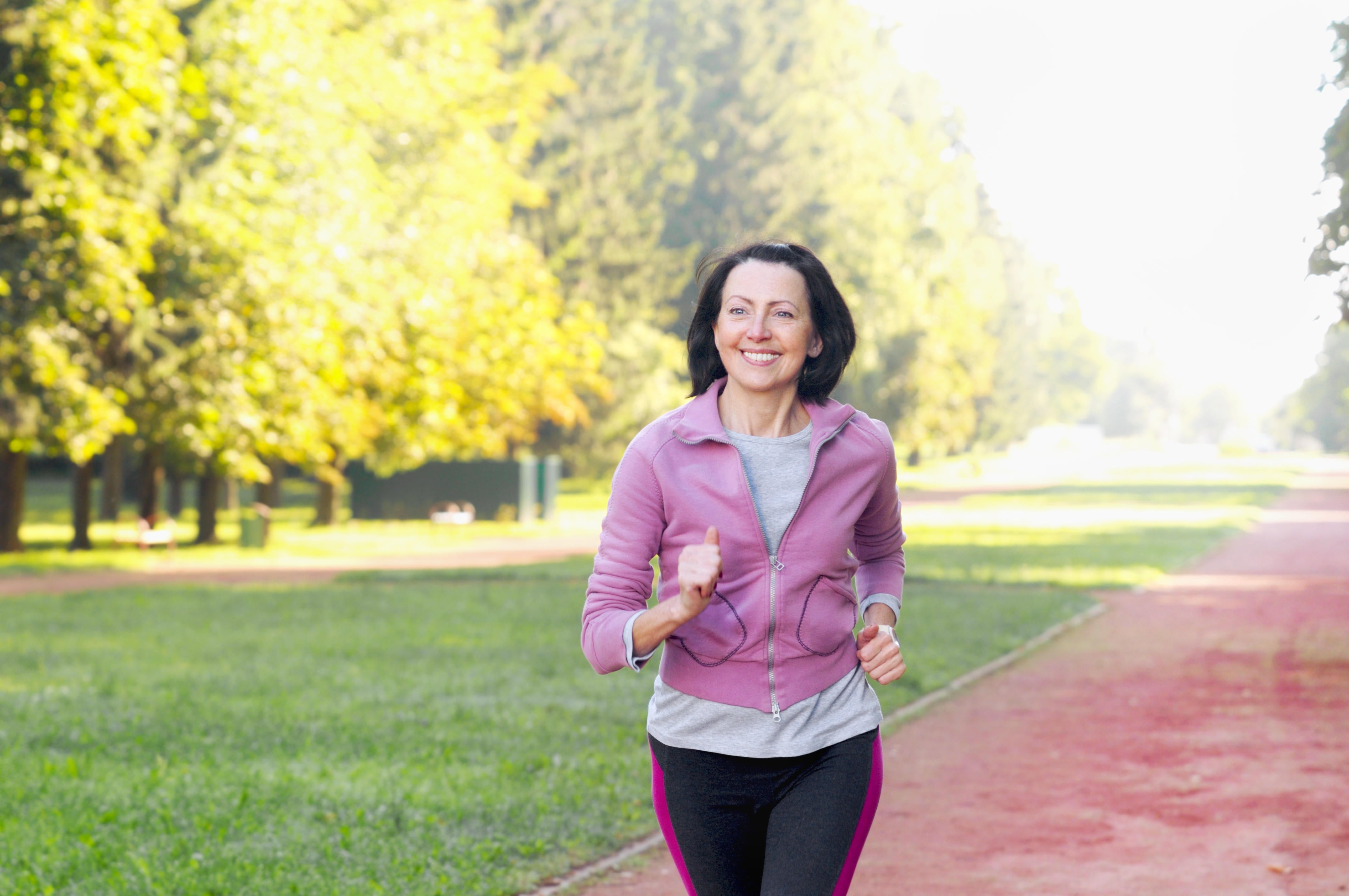 A middle-aged woman running in a park