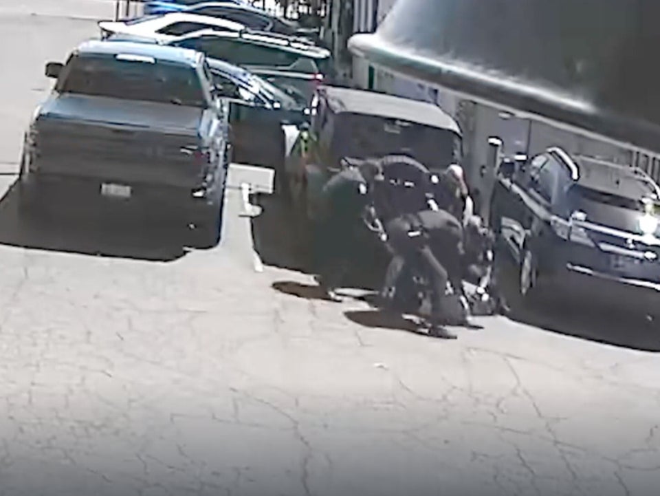 Phoenix police officers hold down Michael Kenyon during an encounter on July 6, 2024, in Phoenix, Arizona. The temperature was 114 degrees Fahrenheit and Kenyon suffered numerous third degree burns to his body from the hot asphalt